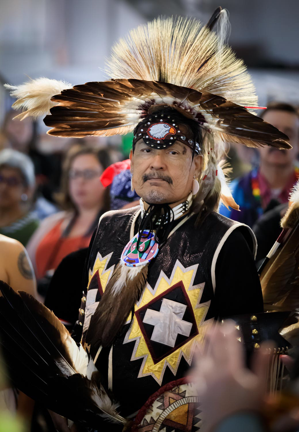 Native American Indian in intricate and colorful traditional outfit at a powwow in San Francisco, USA