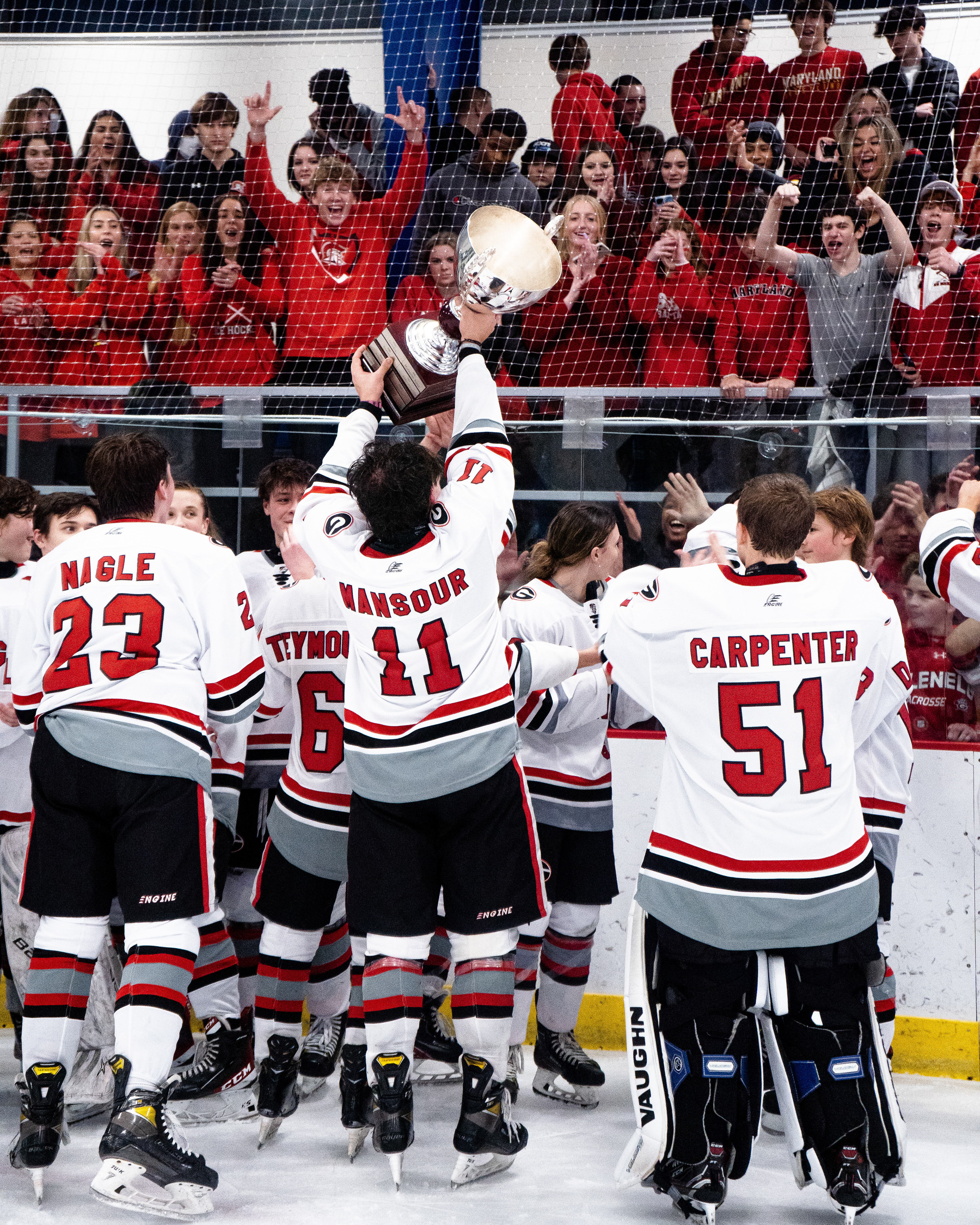 Issa Mansour of Glenelg County lifts the trophy after winning the County Championship