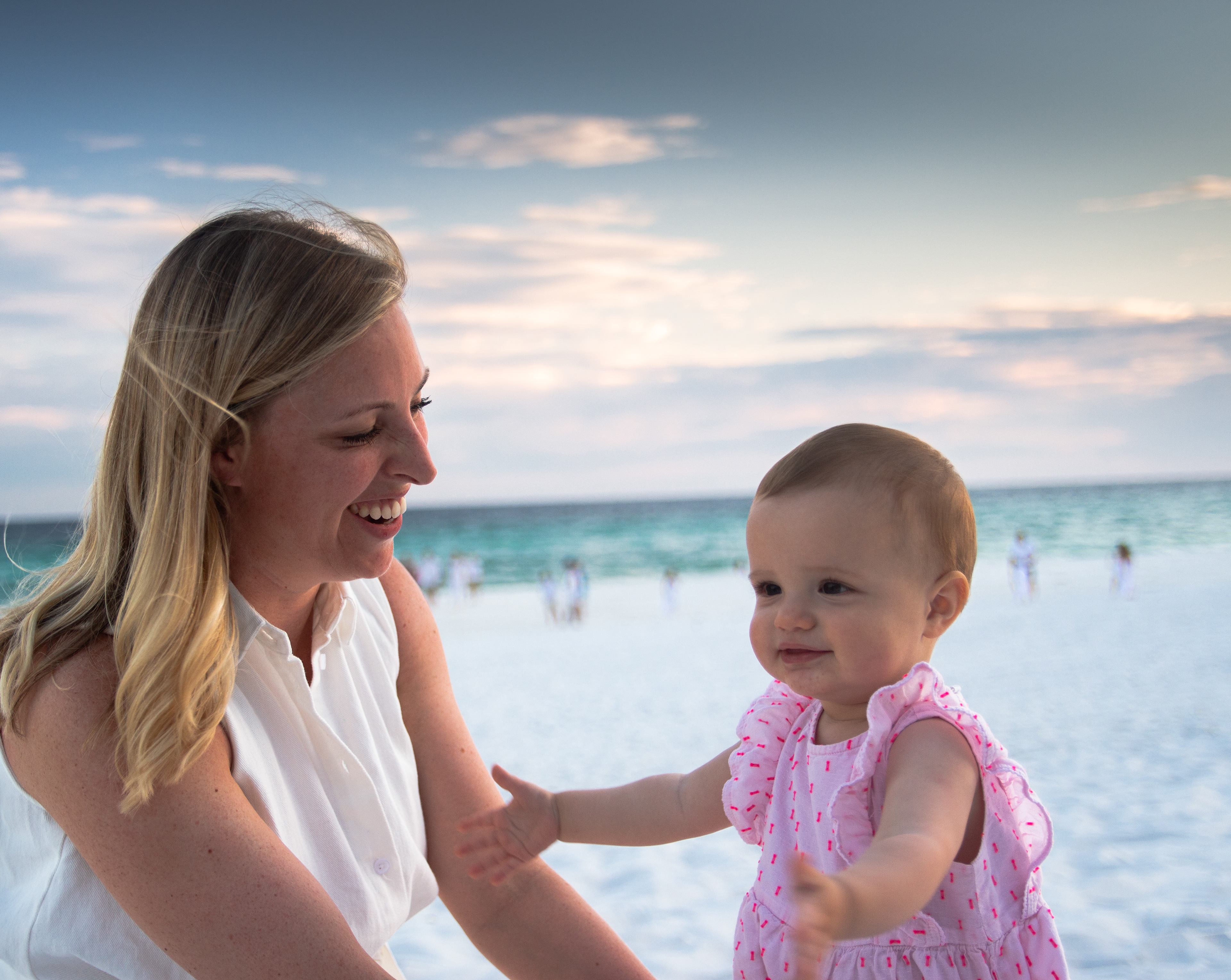 Mother and daughter on the beach at sunset