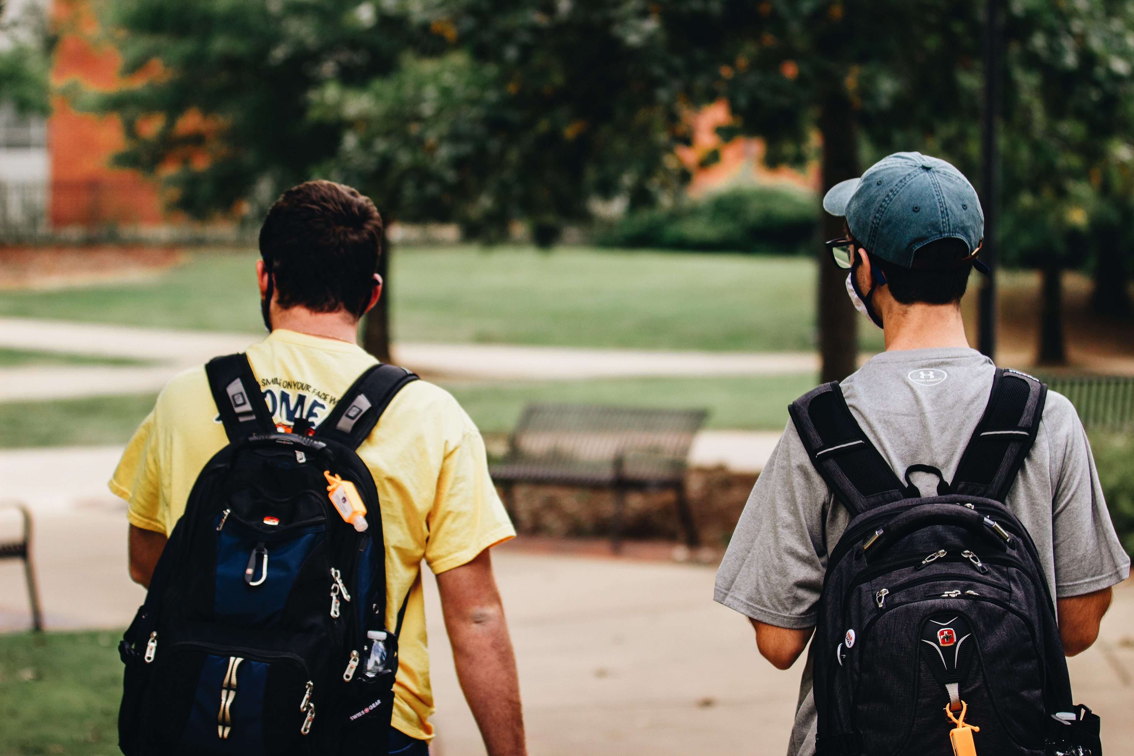 students walking on campus with their masks and hand sanitizer
