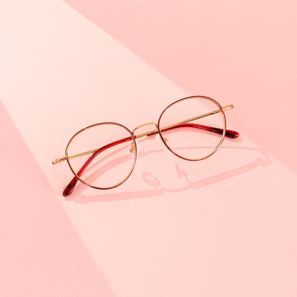 Simple round frames eyewear on a pink background