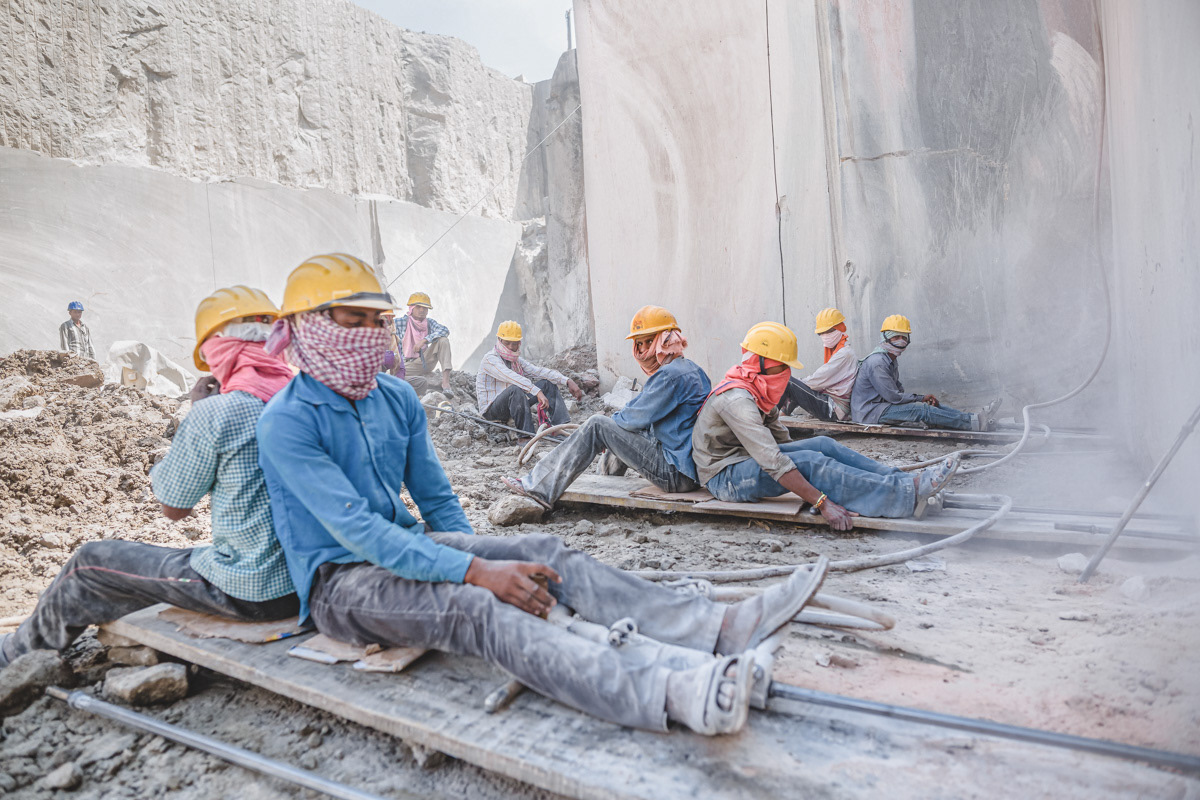 Workers sitting on quarry drilling machines