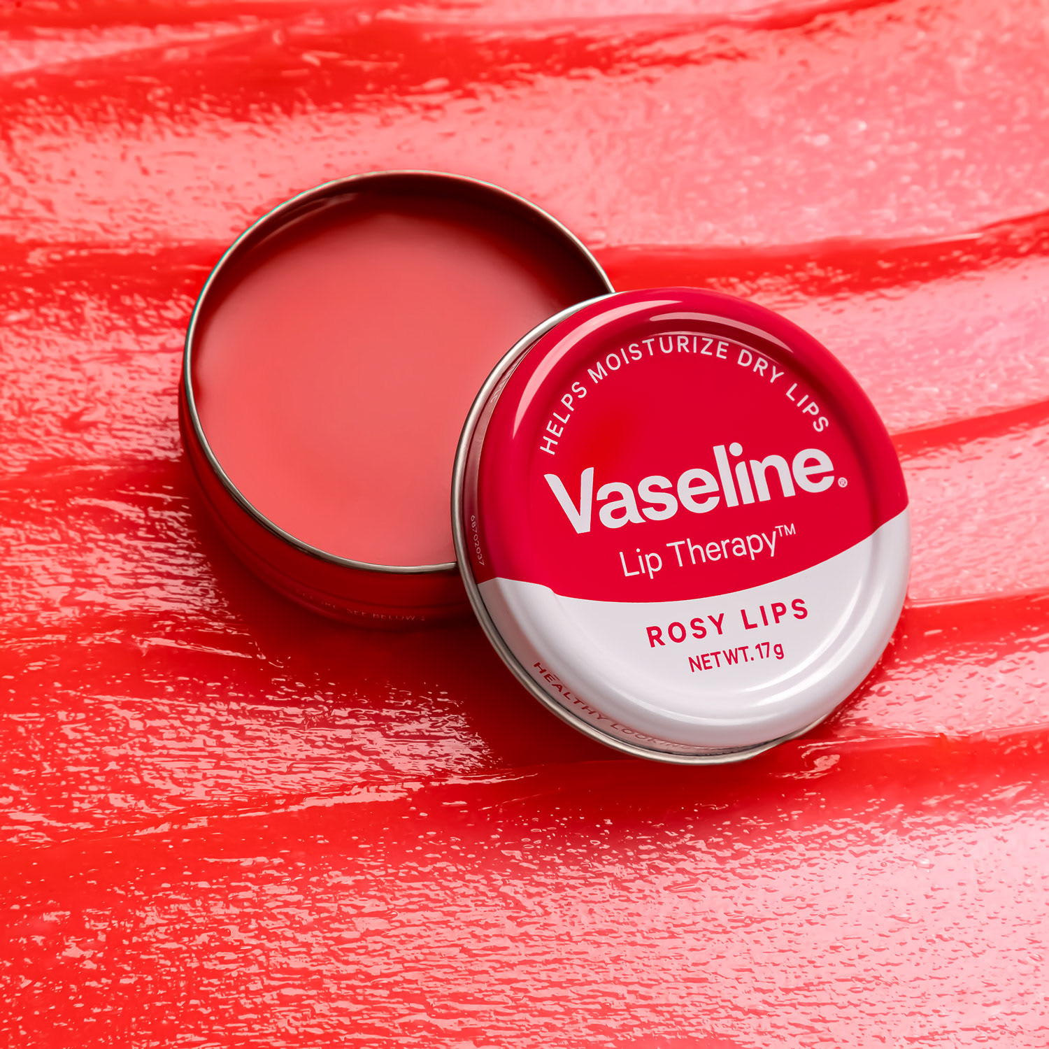 Vaseline Lip Therapy Rosy Lips on a bed of swatched texture