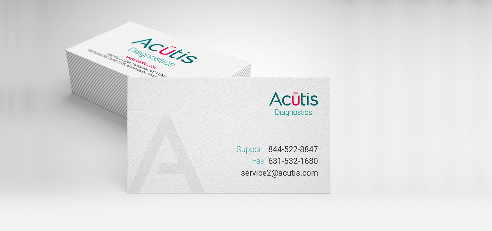 Business card design featuring the updated Acutis Diagnostics logo and brand colors