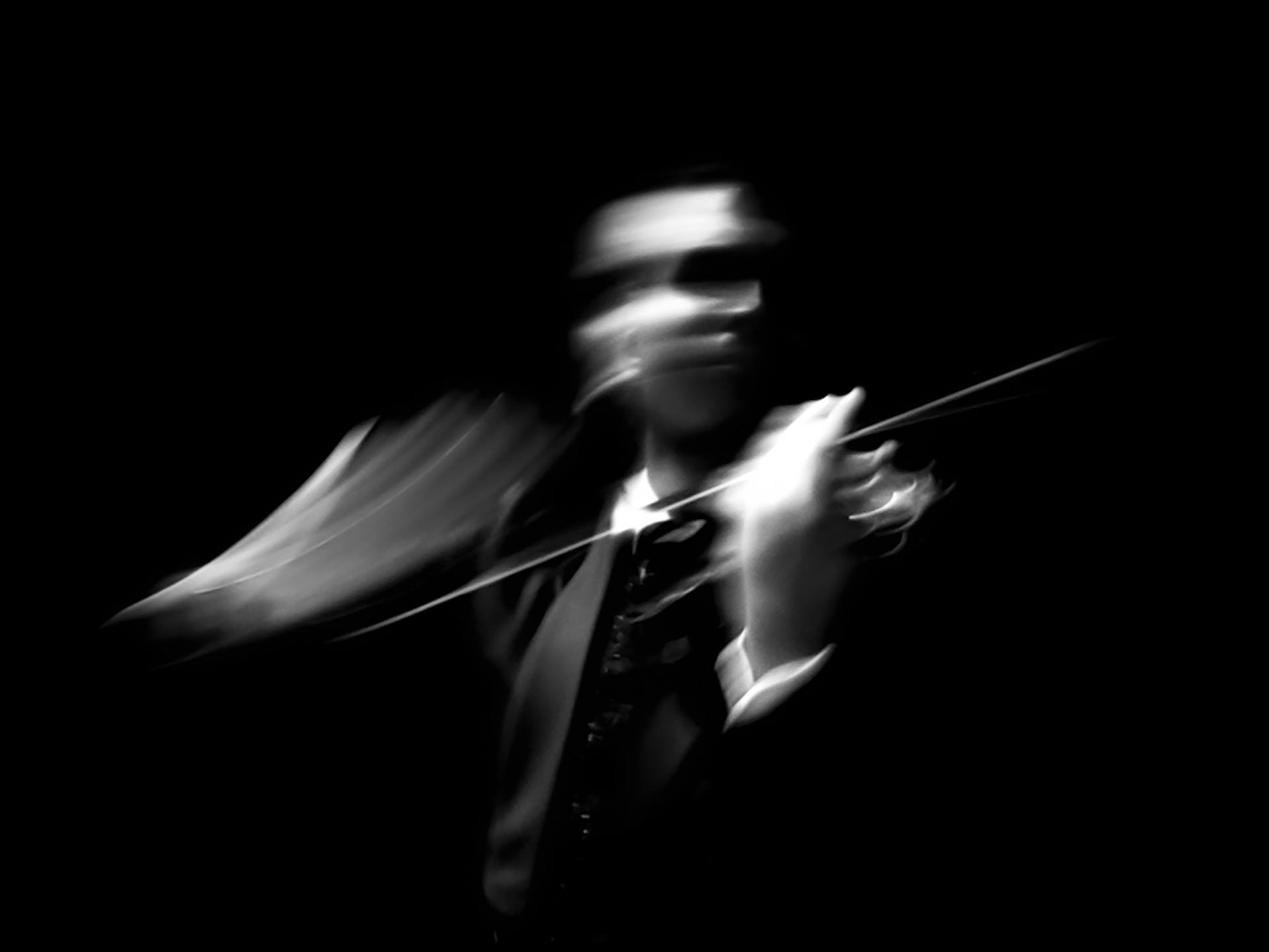 Violinist Brad Repp performing the overture of Madama Butterfly, captured in a graceful and intense gesture.