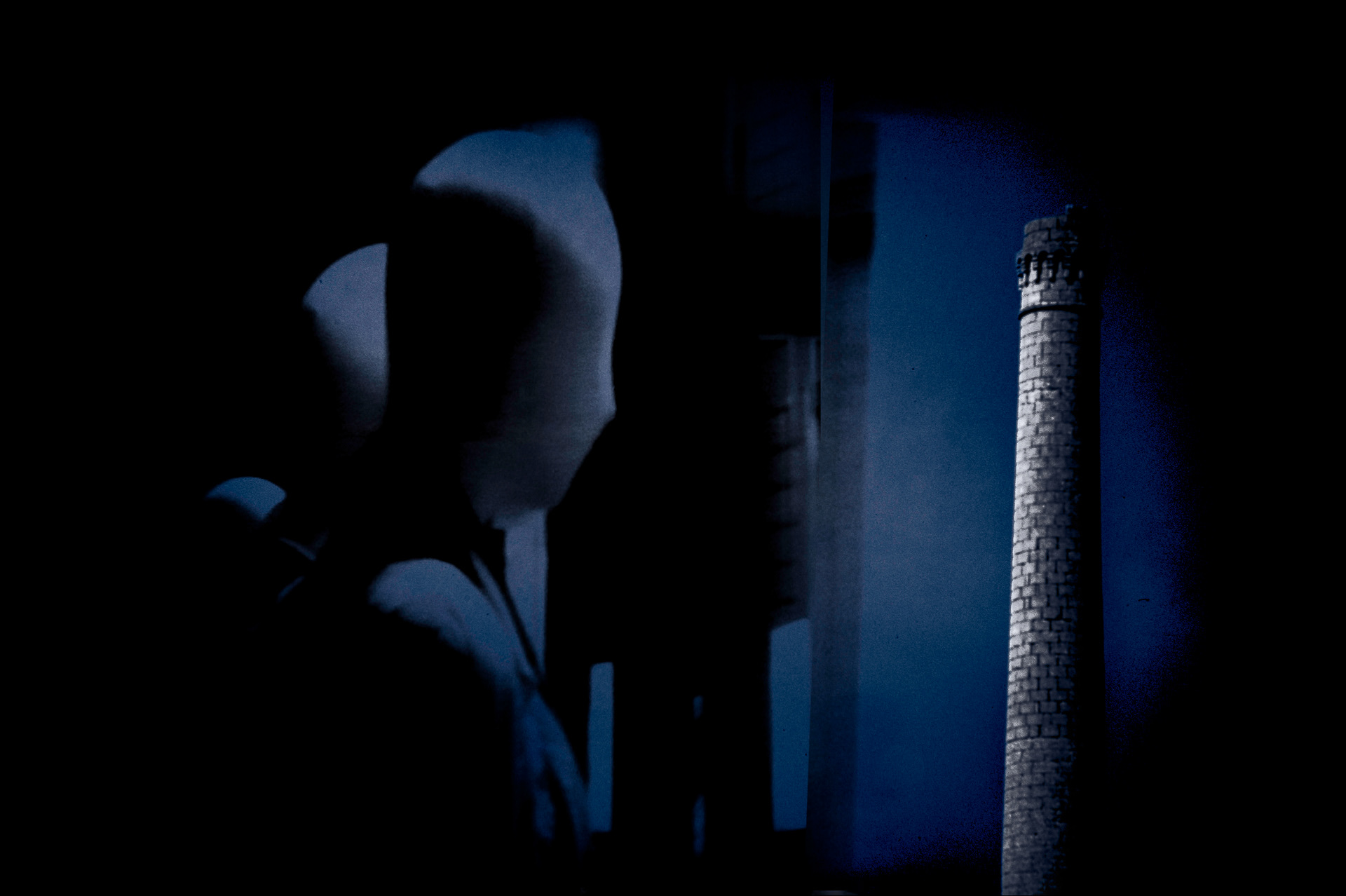Faceless ghostly figure gazes at a distant chimney, immersed in a dark and surreal atmosphere.