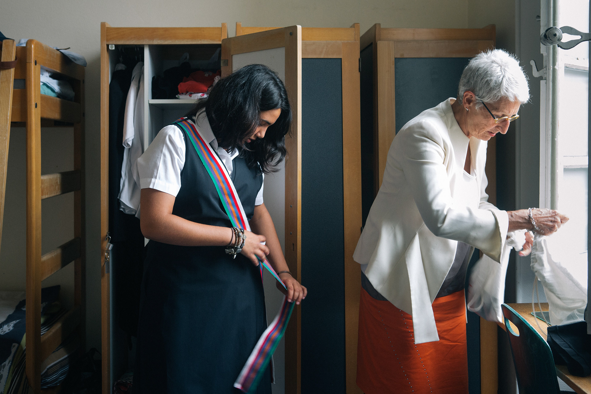 On the first day of school, most girls go to the locker room accompanied by their mother to try on their uniform. The multicolored scarf is the distinctive sign of the pupils of final grade.