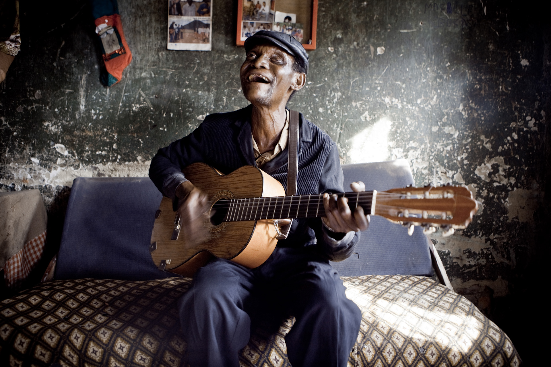 Bokasa Débotsh, guitarist of the Jecoke, is practicing at home, at typical worker's house in the Gécamines district of Lubumbashi.