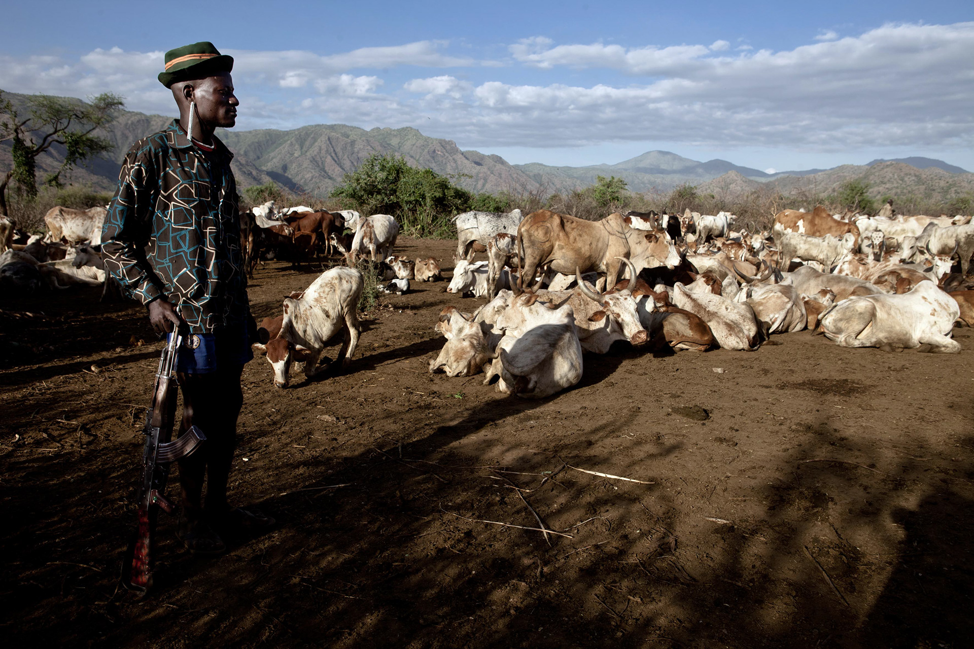 In the distance, the Ugandan mountains where the Turkanas, Tepeth and Dodoth tribes compete for control of water points.