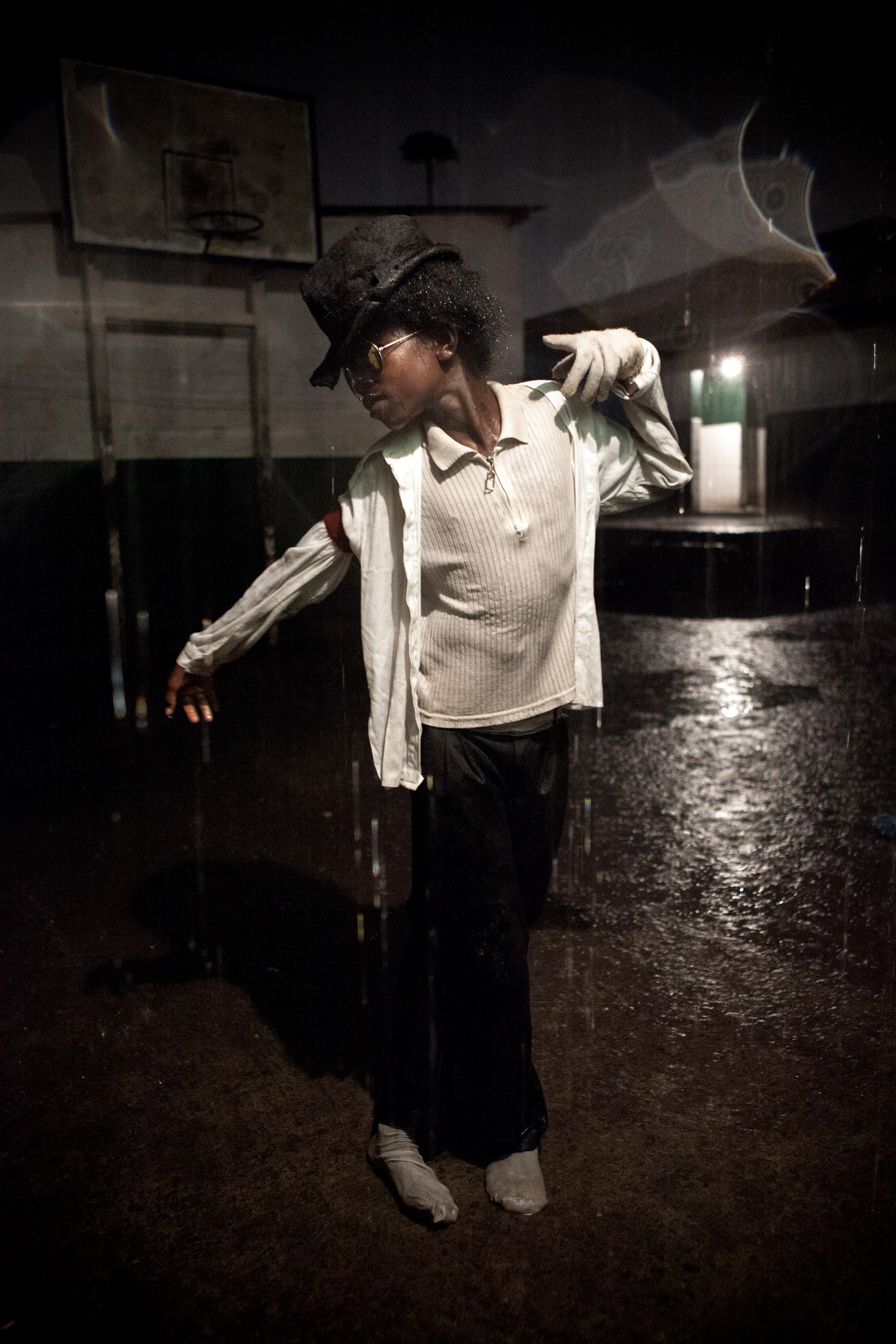 The «little Michael», accused of witchcraft by his aunt after his mother died 2 years ago, practices his imitation of Michael Jackson dance, a show he performs every night to make a living in Kinshasa.