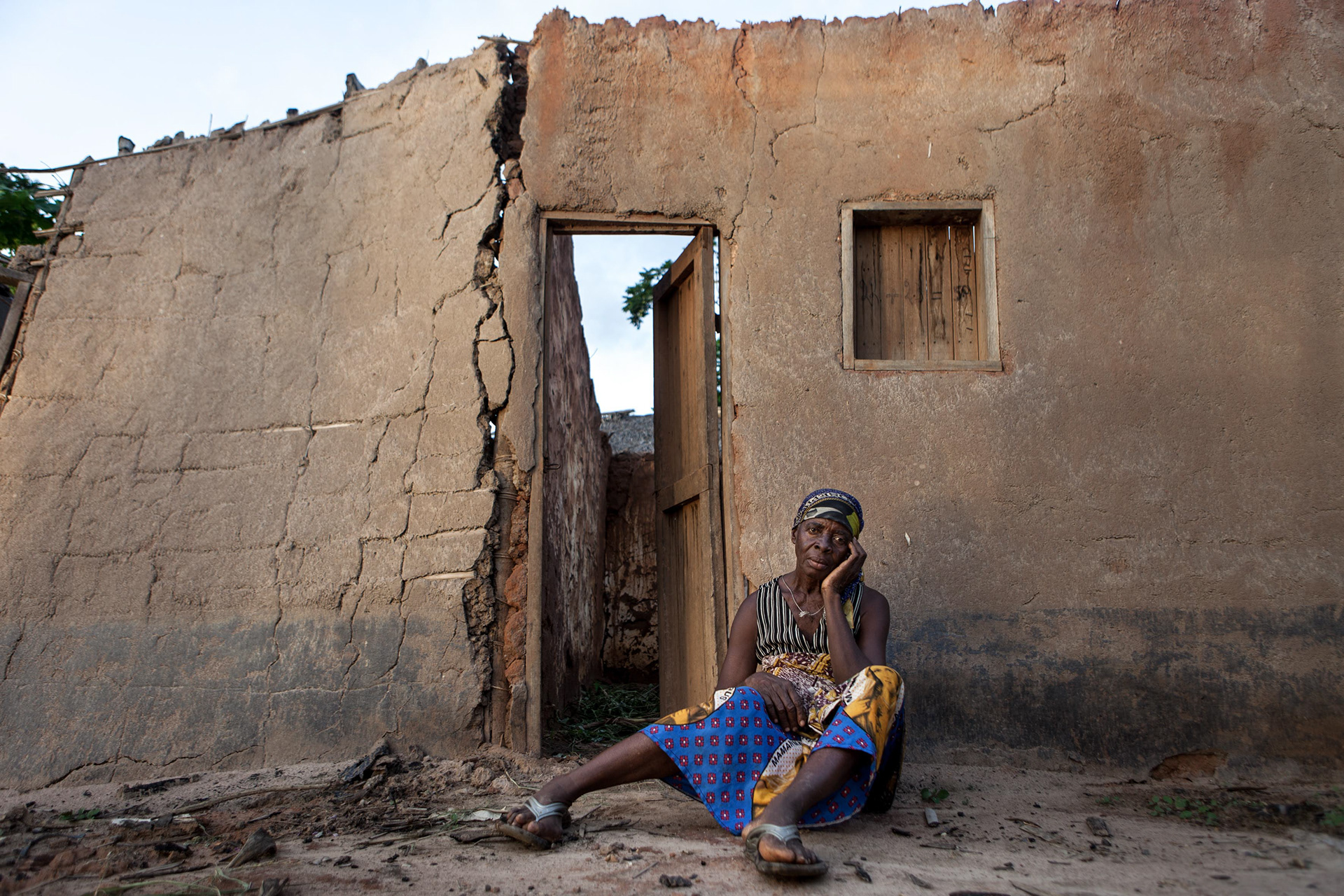 Nyanzala sits in front of her house in Dongo, Equateur province, DRC on April 24, 2010. She lost her husband when the fishermen from Enyele attacked Dongo on October 29th, 2009. Having fled to Congo Brazzaville, on the other side of the Ubangui river, she returned only to find her house destroyed. Since the end of October, 2009, 187,000 have fled the fighting, among which 109,000 and 18,000 respectively in the neighbouring Republic of Congo and in the Central African Republic.