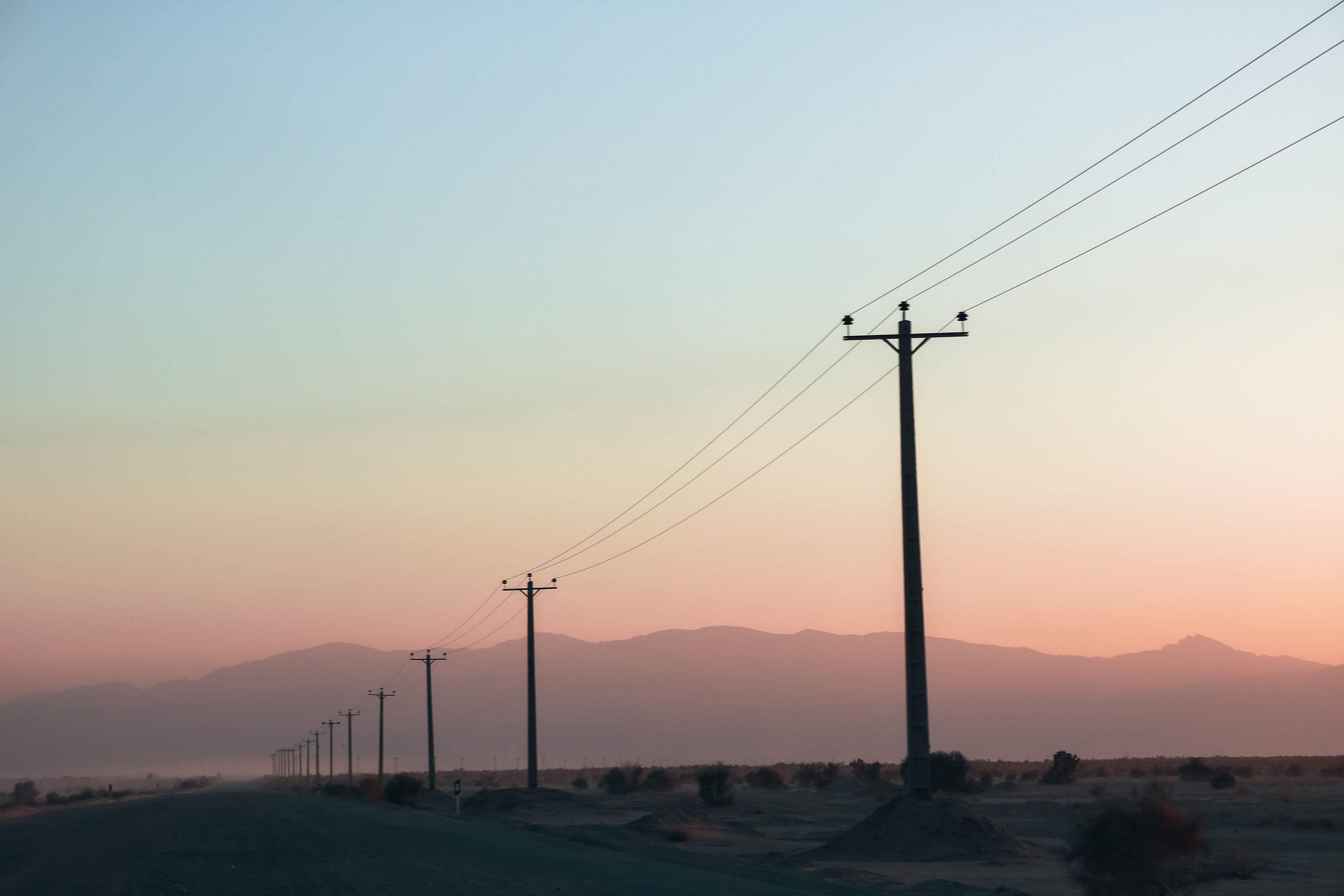 Iran, Isfahan Province. Pink and misty sunset on the ride back from Maranjab Desert to Isfahan.