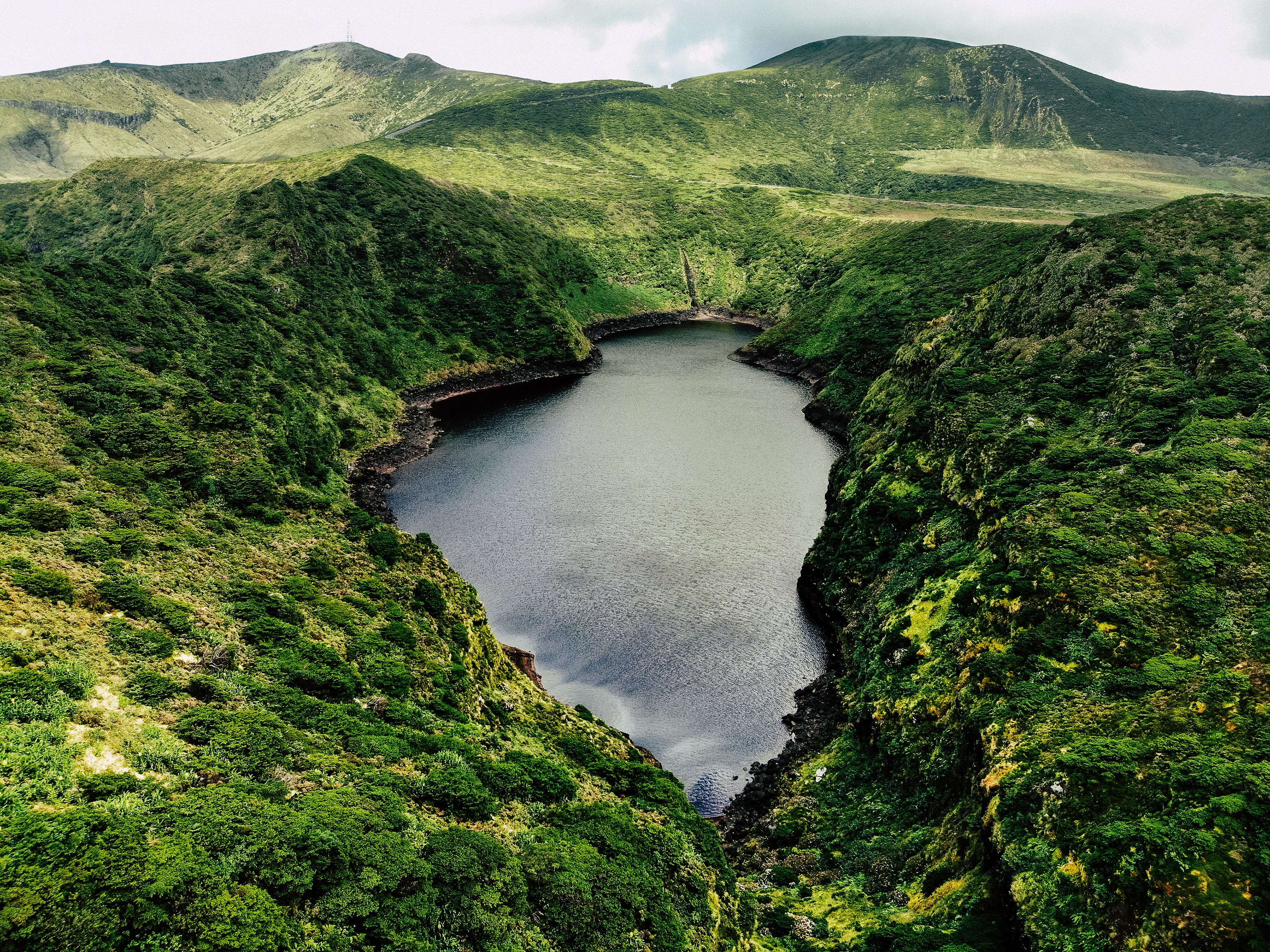 Azores, Ilha das Flores. A mysterious lake hidden between the green hills of Flores island in Azores.