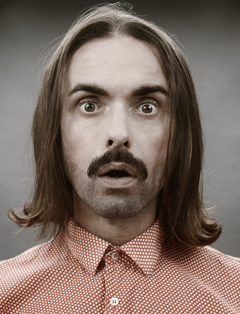 Long haired and amazed, I look into the camera for a retro-style portrait