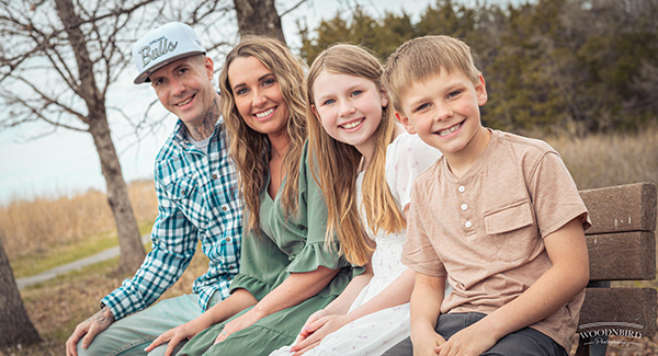 Family of four seated outdoors