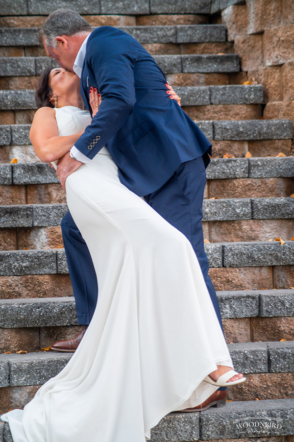 Groom lifting bride on steps