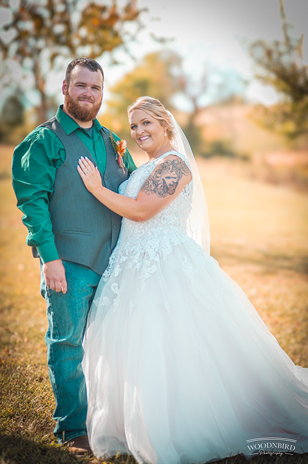 Bride and groom in field
