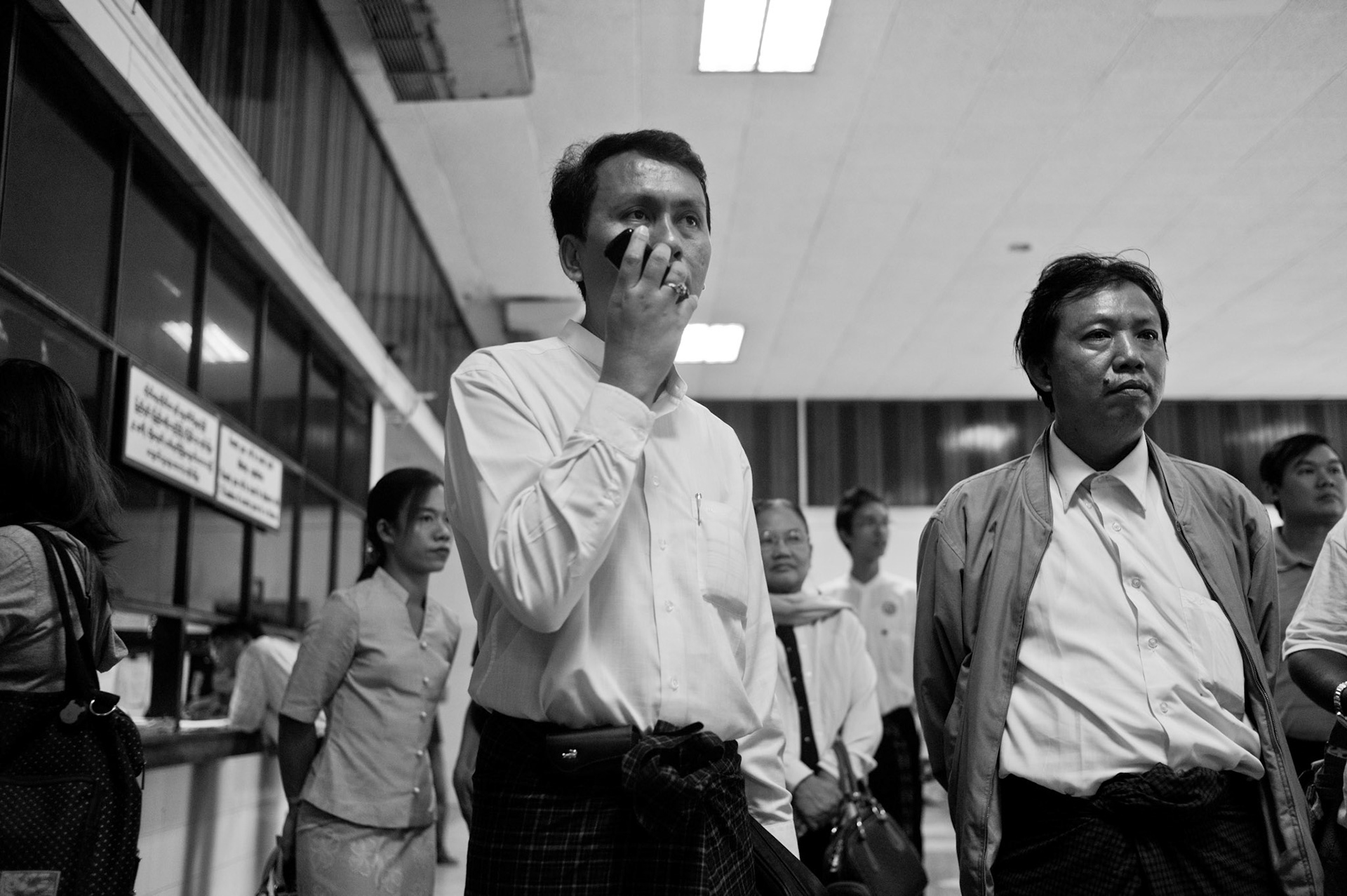 Phyo Min Thein gives an interview over the phone to foreign media whilst waiting for his brother-in-law and leader of the 88 Generation Students, Htay Kywe, to arrive. The Presidential amnesty saw more than 600 political prisoners released from prison, many of who were former leaders of the mass democracy uprising in 1988 and were serving long sentences of 65 years or more.