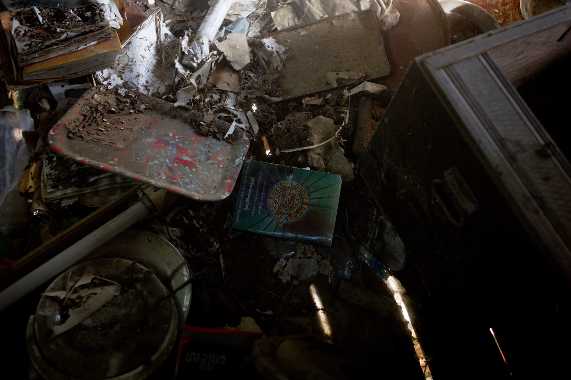 Religious books lie scattered on the ground, many torn into pieces by the soldiers as they ransacked the monastery. On September 26th 2007, at the height of Burma's monk led Saffron Revolution, Maggin Monastery in Rangoon, was raided as the regime commenced its brutal crackdown on the protests. On 13th January 2012 the monks were released from prison and more than four years since the monastery was raided and locked, they returned and opened the doors once more. Everything they found was exactly as it was left the night the military regime arrested them and ransacked the buildings.