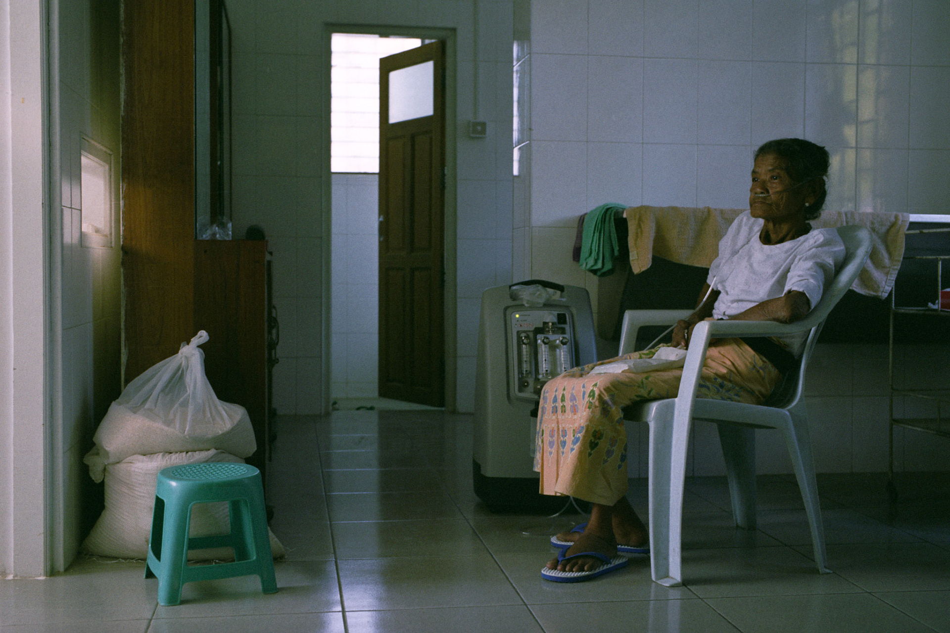 An elderly lady with emphysema is cared for at the centre that can provide oxygen thanks to donations from foreign donors