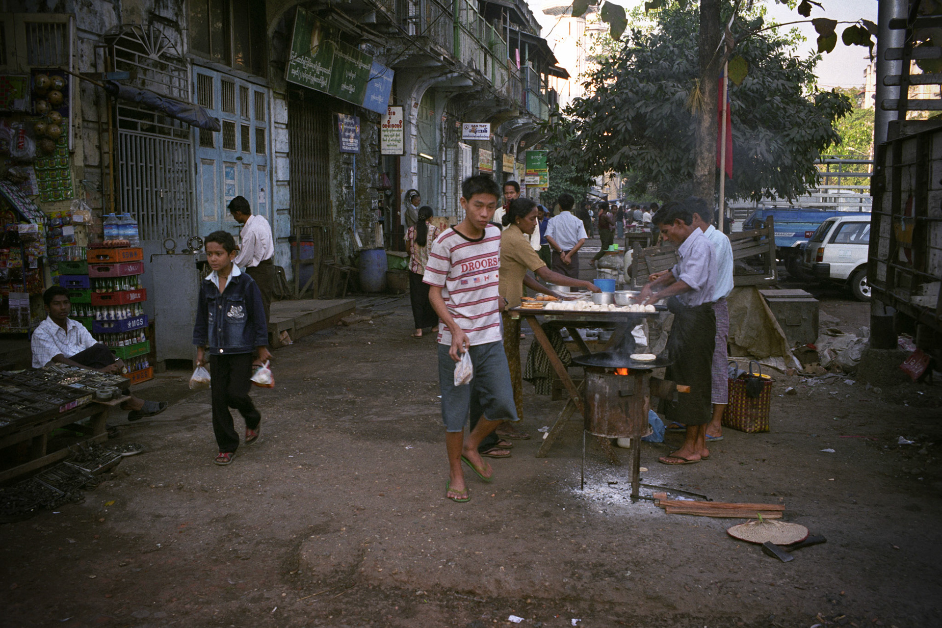 Daily life on the streets of Rangoon where vendors offer everything for sale from fresh food to bric-brac and discarded items. Burma, a resource rich nation, has become one of the poorest in the world with estimated more than 30% of the population living on or below the poverty line and where the ruling military regime spend less than 2% of GDP on education and healthcare combined.