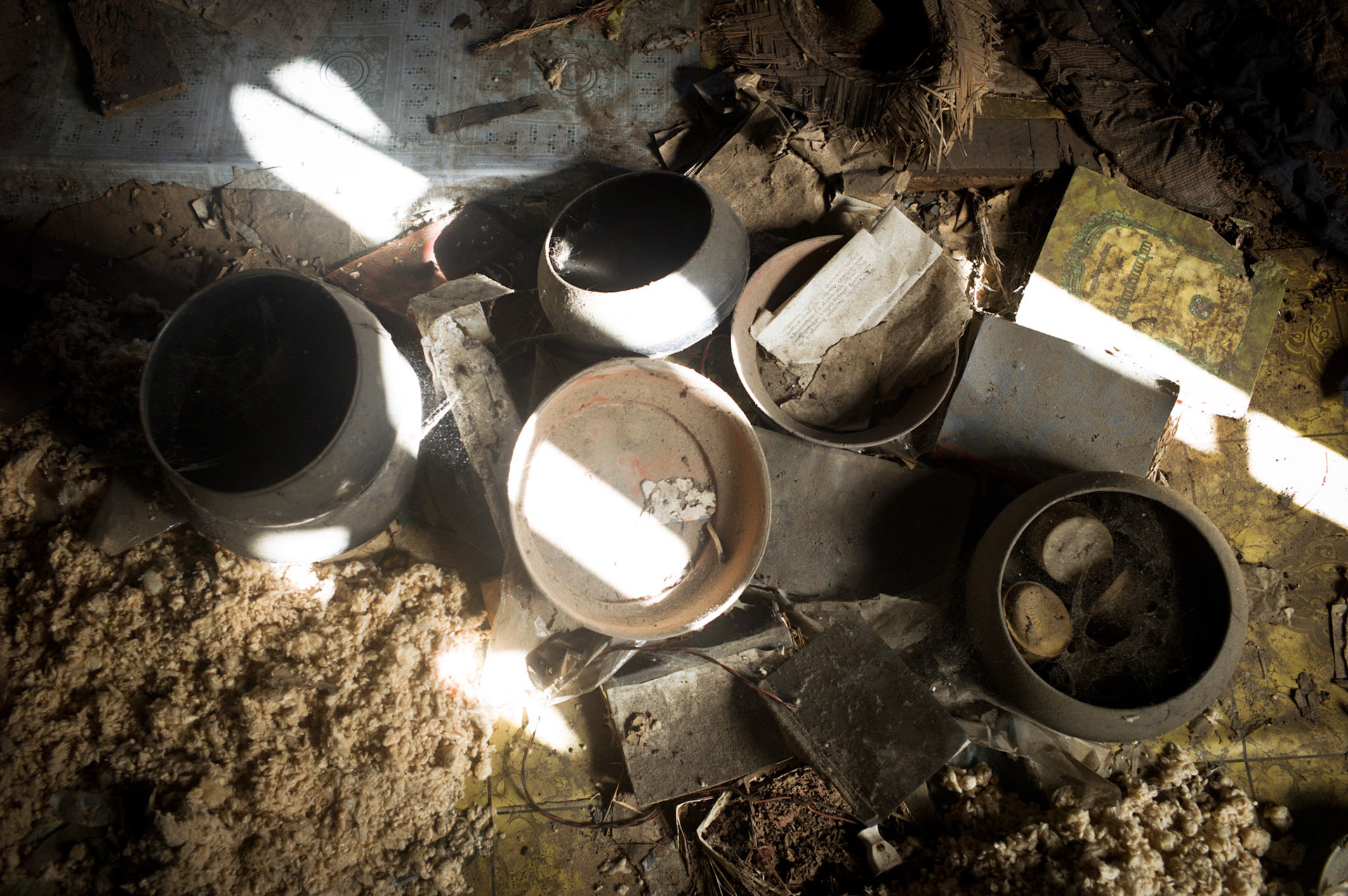 Monks alms bowls lie on the floor gathering dust. Nothing has been touched for mroe than four years. On September 26th 2007, at the height of Burma's monk led Saffron Revolution, Maggin Monastery in Rangoon, was raided as the regime commenced its brutal crackdown on the protests. On 13th January 2012 the monks were released from prison and more than four years since the monastery was raided and locked, they returned and opened the doors once more. Everything they found was exactly as it was left the night the military regime arrested them and ransacked the buildings.