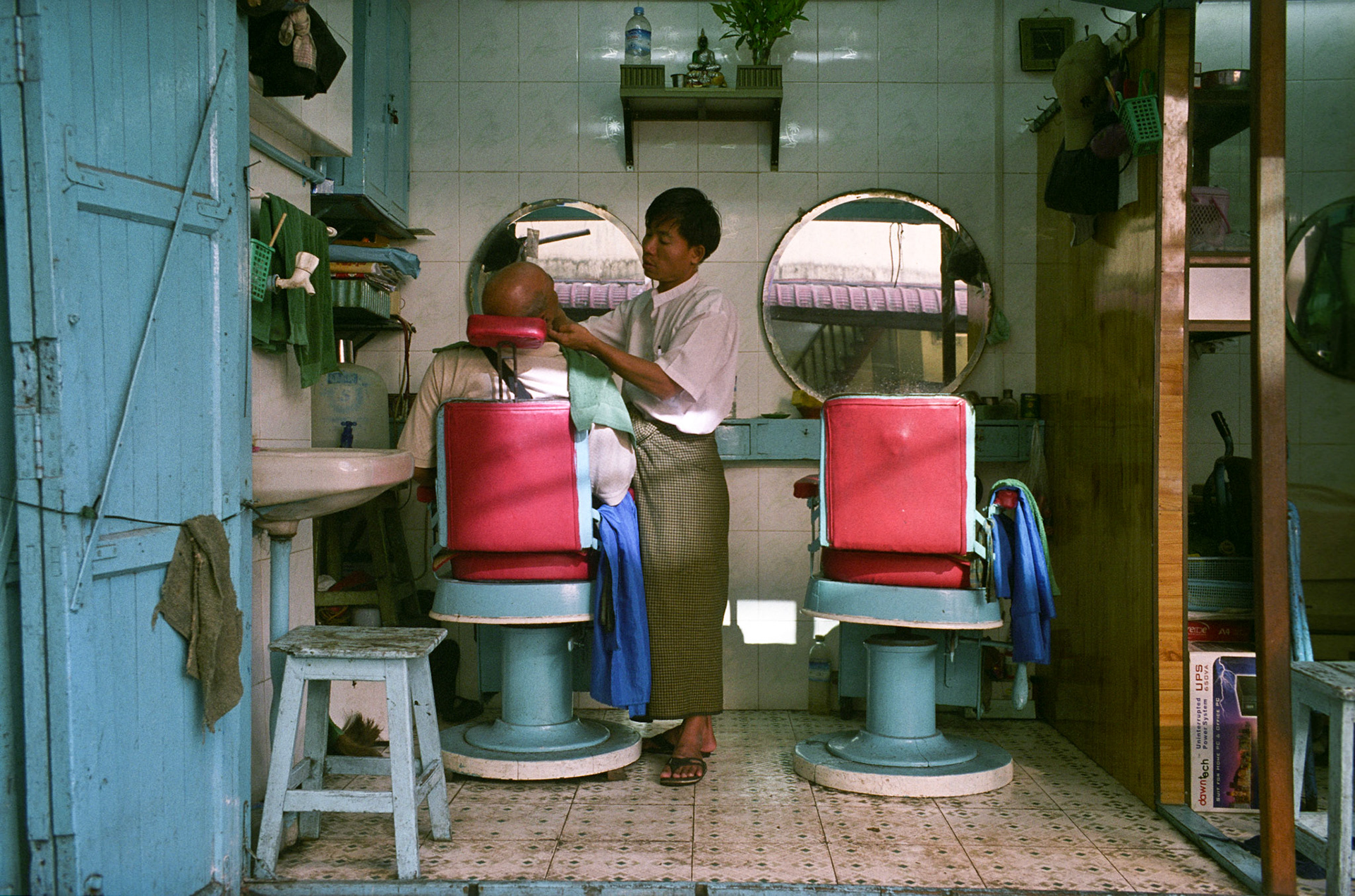Daily life on the streets of Rangoon where vendors offer everything for sale from fresh food to bric-brac and discarded items. Burma, a resource rich nation, has become one of the poorest in the world with estimated more than 30% of the population living on or below the poverty line and where the ruling military regime spend less than 2% of GDP on education and healthcare combined.
