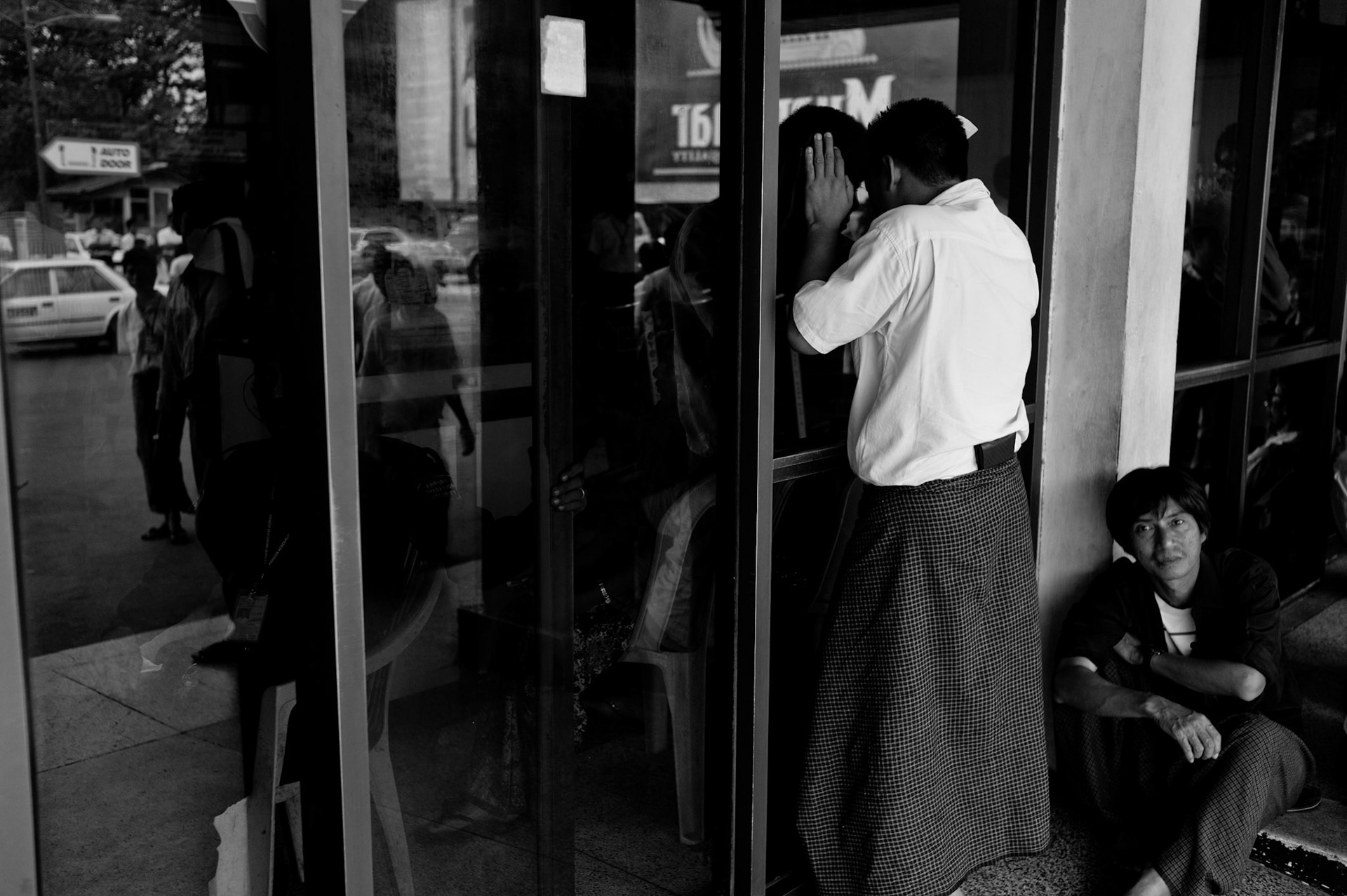 Military Intelligence keep watch as near to a thousand people gather at Rangoon airport to greet the arrival of the 88 Generation Students who have been released from prison. The Presidential amnesty saw more than 600 political prisoners released from prison, many of who were former leaders of the mass democracy uprising in 1988 and were serving long sentences of 65 years or more.