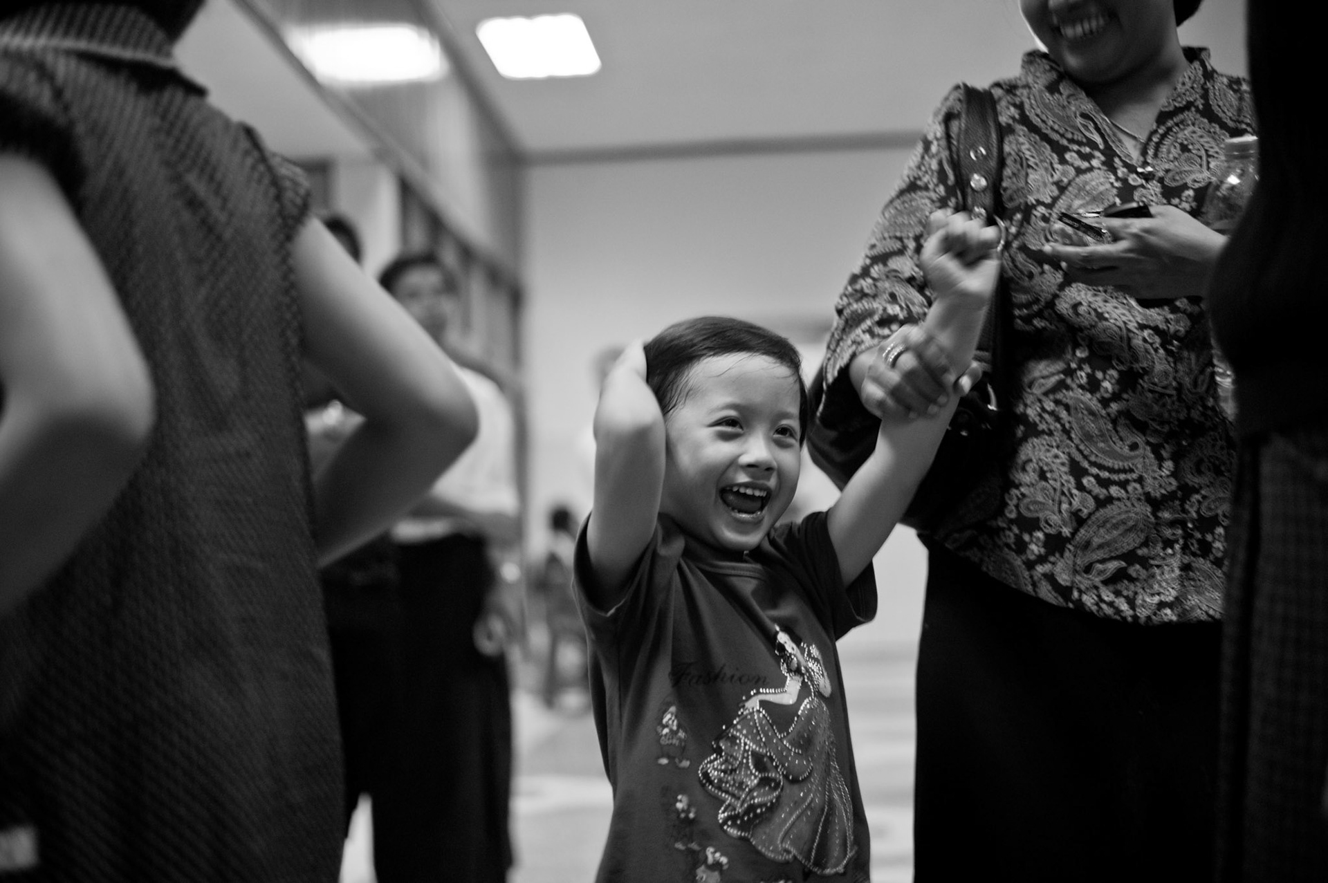 Phyu Nay Kyi screams with joy as her fathers plane touches down at Rangoon airport. Today is the first time since she was born that she will be with both of her parents. The Presidential amnesty saw more than 600 political prisoners released from prison, many of who were former leaders of the mass democracy uprising in 1988 and were serving long sentences of 65 years or more.