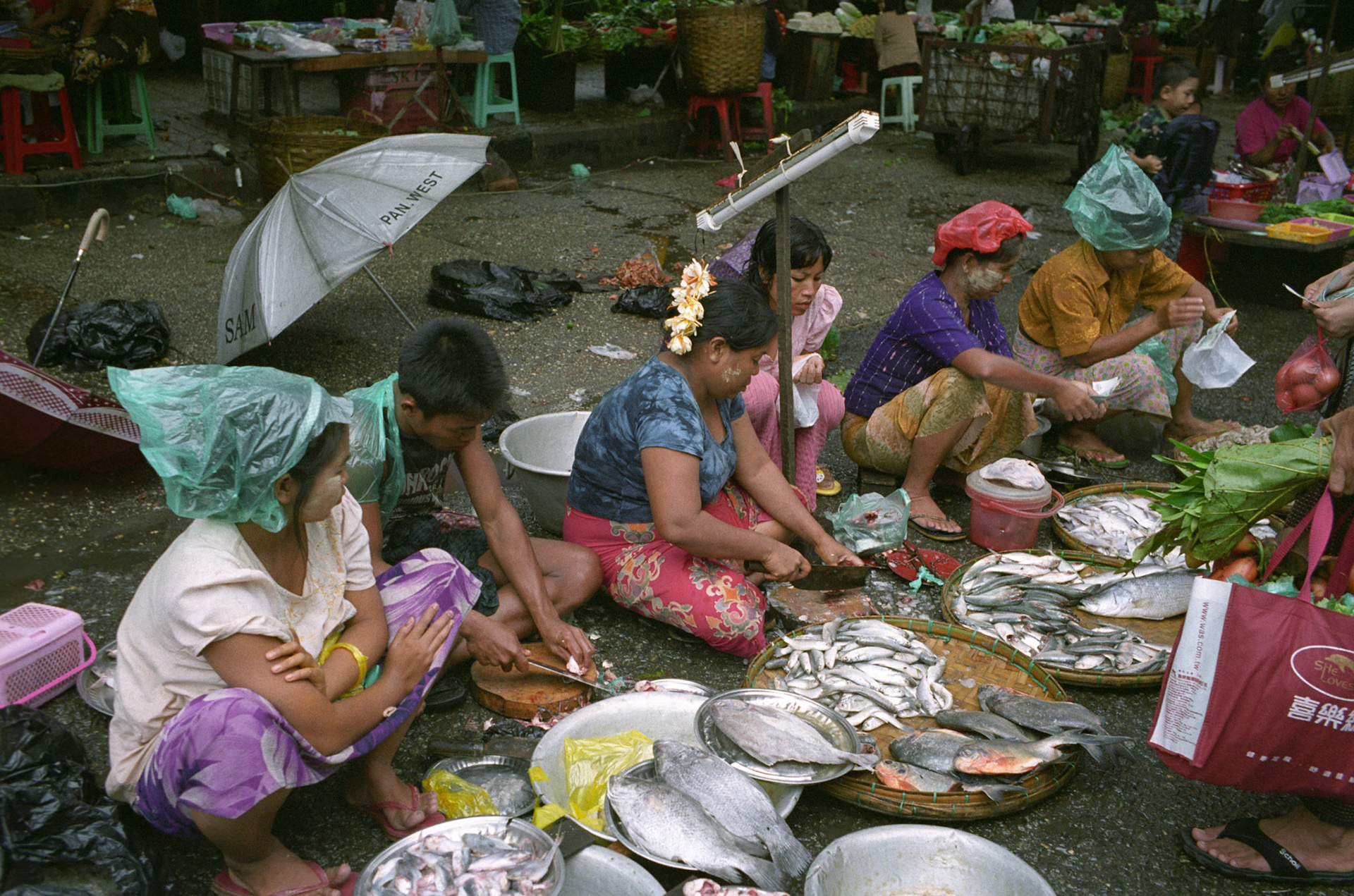 Daily life on the streets of Rangoon where vendors offer everything for sale from fresh food to bric-brac and discarded items. Burma, a resource rich nation, has become one of the poorest in the world with estimated more than 30% of the population living on or below the poverty line and where the ruling military regime spend less than 2% of GDP on education and healthcare combined.