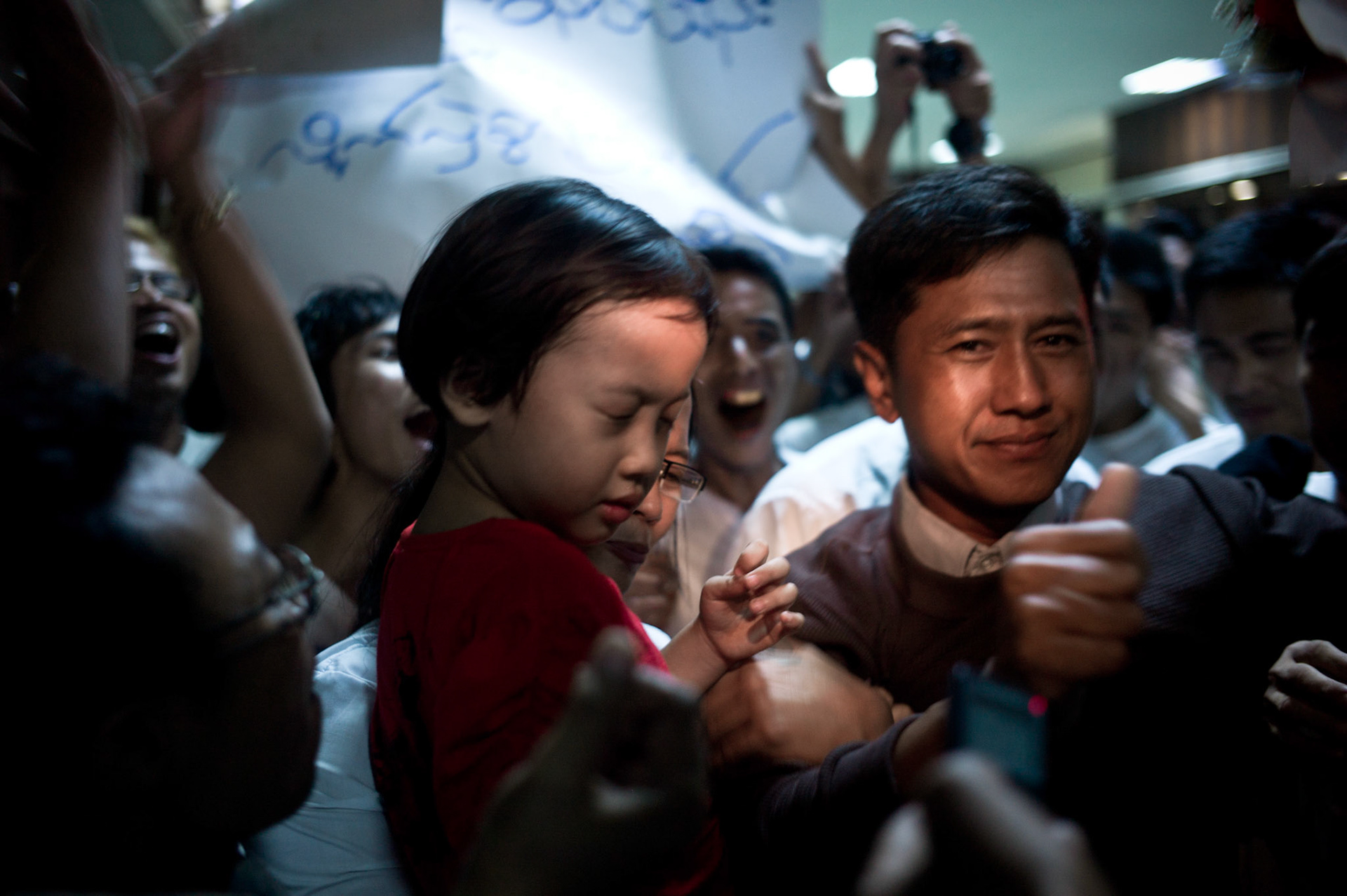 Crowds overwhelmed with joy mob Nilar Thein, Ko Jimmy and Phyu Nay Kyi as they try to leave the airport