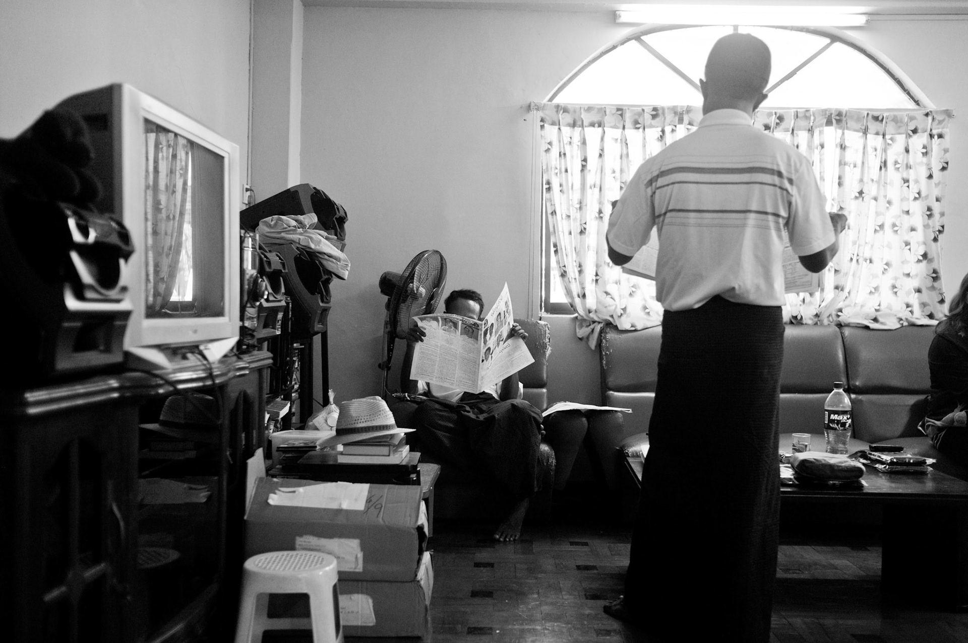 Kyaw Kyaw Htwe 'Marky' and Zaya catch up on reading the newspapers. They were both freed from their 65 years sentences just days before.