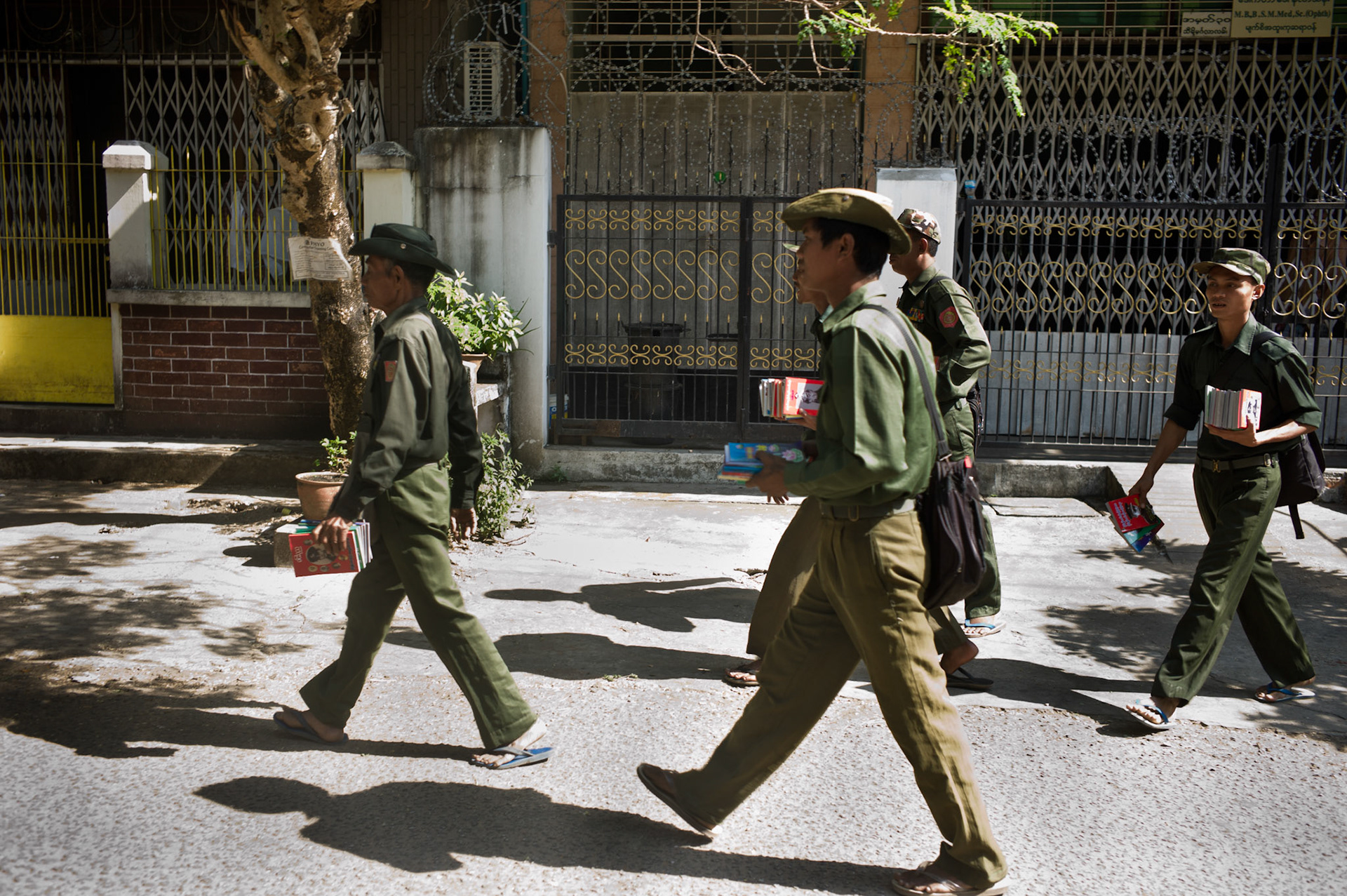 Soldiers from the Burmese army, the Tatmadaw, walk the streets of downtown Rangoon selling books about General Aung San. As founder of Burma's army and gaining the country's independence, he plays a hugely important role in society. However for decades his image and that of his daughter Aung San Suu Kyi have been outlawed from being on display and punishable with imprisonment if caught