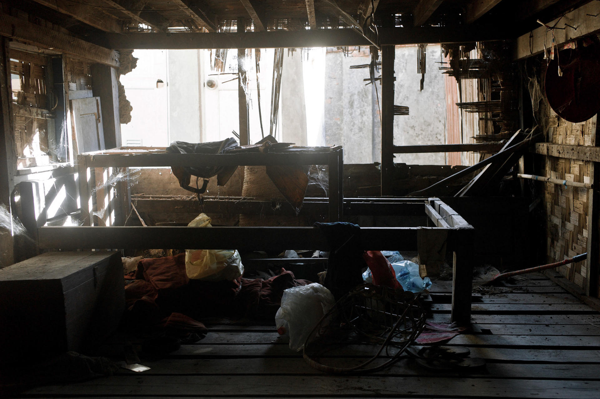 Sleeping quarters destroyed by the soldiers who smashed through the bamboo walls as they tried to arrest the monks. On September 26th 2007, at the height of Burma's monk led Saffron Revolution, Maggin Monastery in Rangoon, was raided as the regime commenced its brutal crackdown on the protests. On 13th January 2012 the monks were released from prison and more than four years since the monastery was raided and locked, they returned and opened the doors once more. Everything they found was exactly as it was left the night the military regime arrested them and ransacked the buildings.