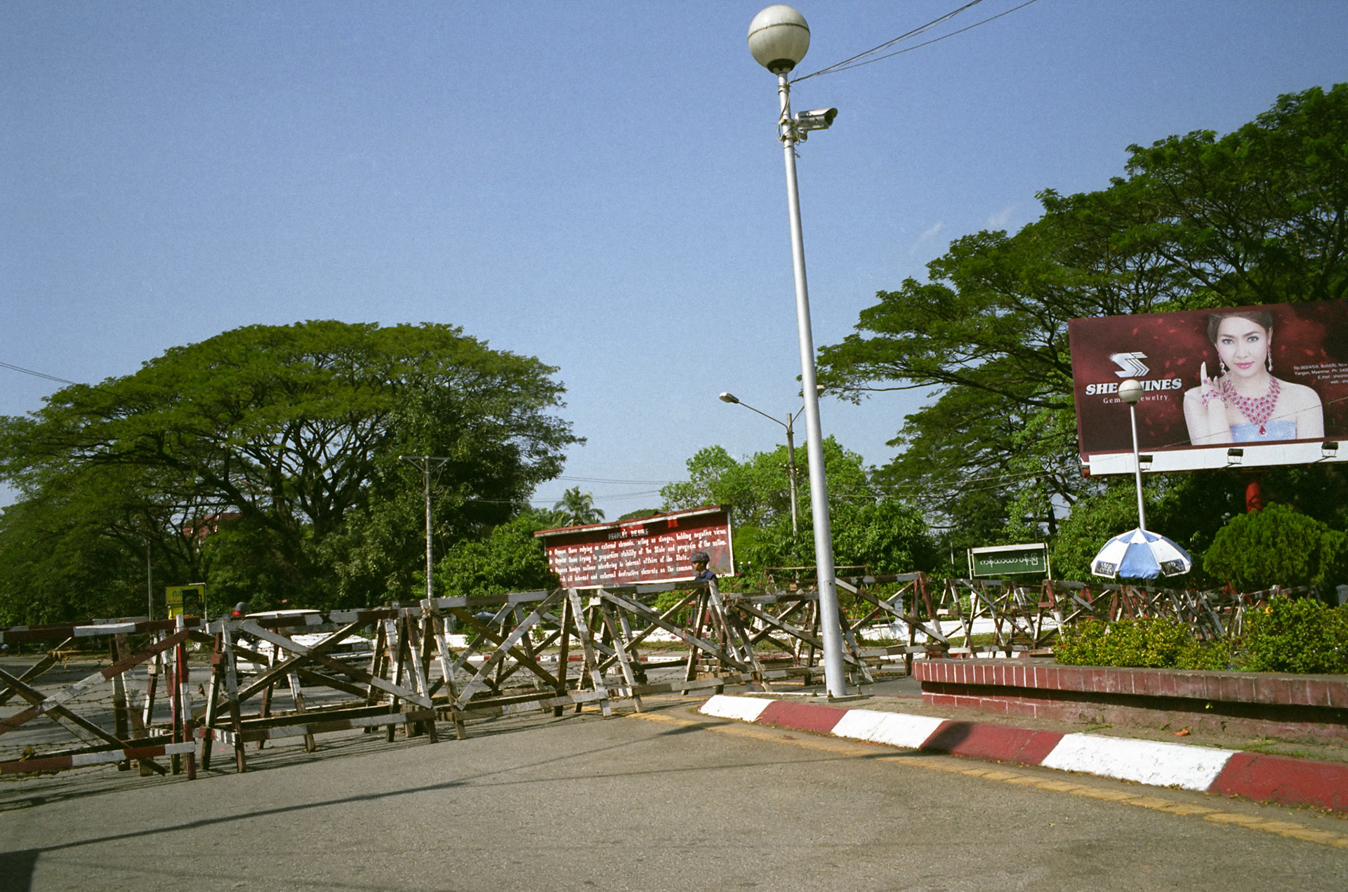 Military blockades across University Avenue in Rangoon stop all traffic and pedestrians from entering the road where Aung San Suu Kyi has been held under house arrest for the past 11 years