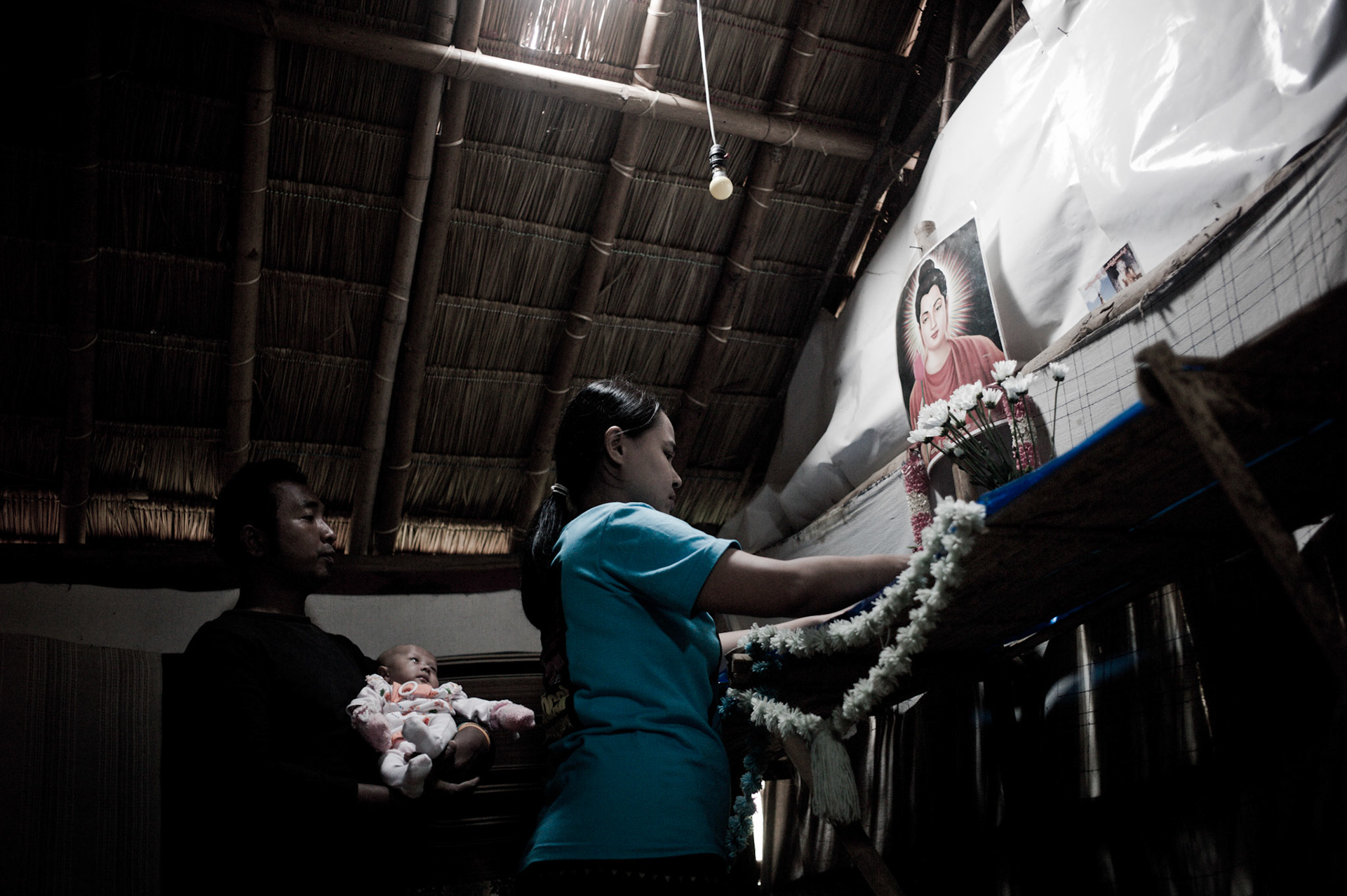 Like most Burmese, buddhism plays an important role in daily life. Thin Min Soe and her husband Soe Myint also a former political prisoner from Burma make offerings every morning from the meagre rations that they receive.