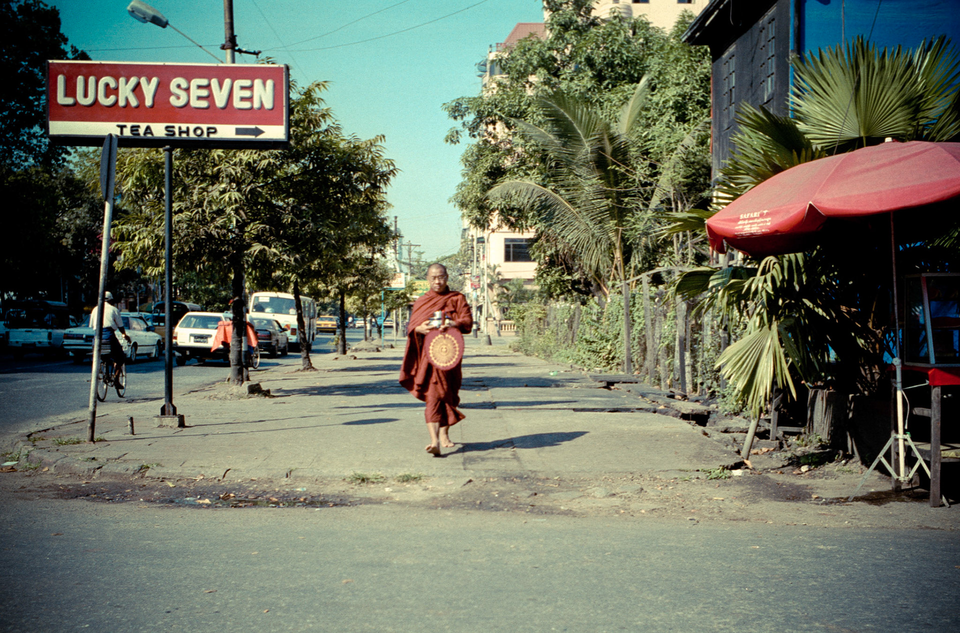 Monk collecting his morning alms in downtown Rangoon