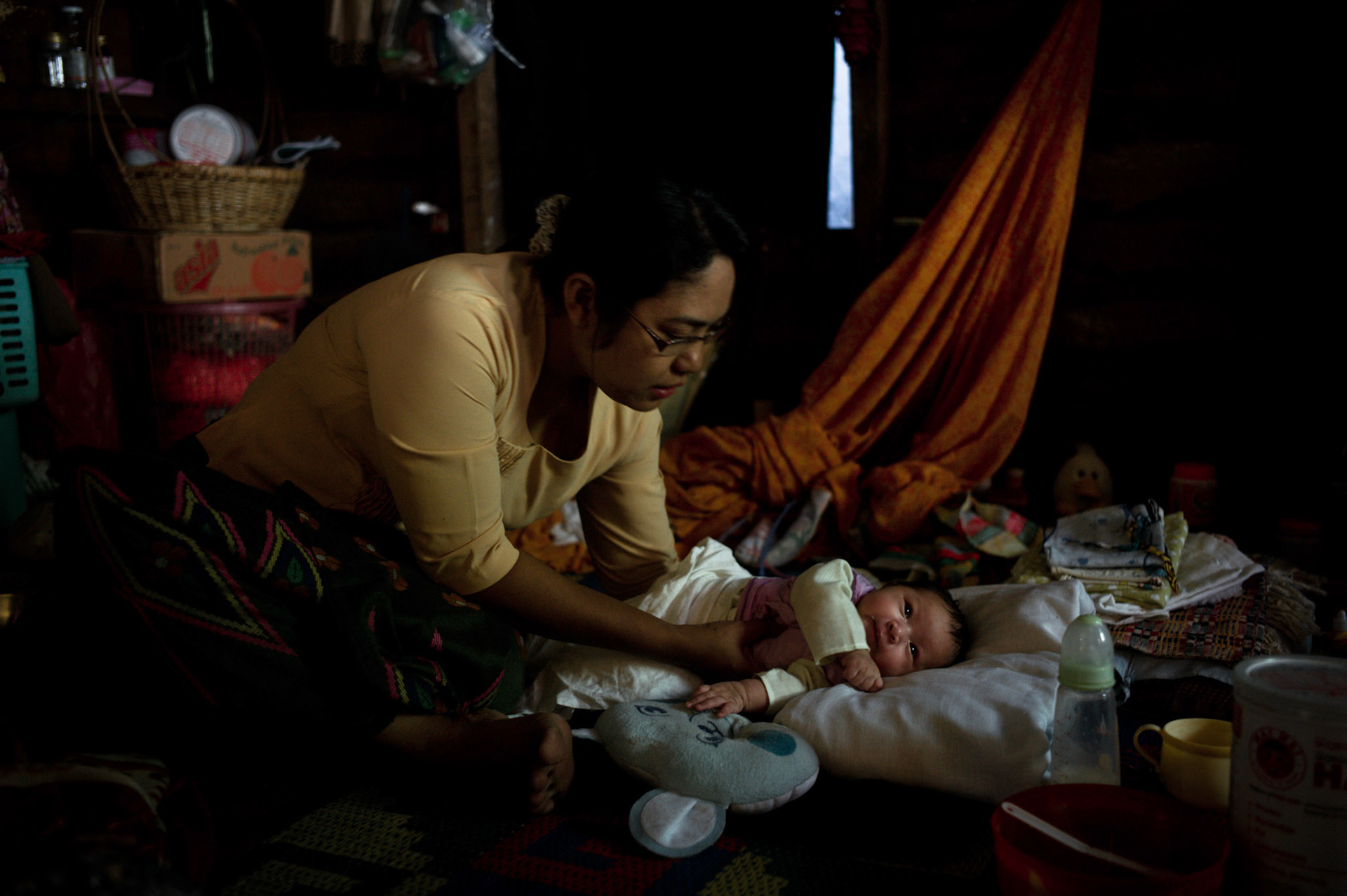 Phyu Phyu Thin attends to 16 day old baby girl Shi La Nyunt who has tested negative despite her mother being HIV positive. The HIV/AIDS clinic in South Dagon, Rangoon, provides more than 200 patients with free treatment and care. There are an estimated 336,000 HIV positive people in Burma, yet only 10% receive treatment in a country where the government spends the least percentage of its GDP on health care of any country in the world.