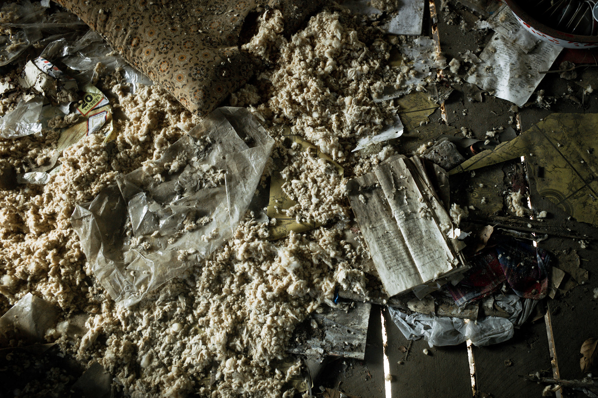 Religious books torn into pieces by soldiers lie scattered amongst the debris. On September 26th 2007, at the height of Burma's monk led Saffron Revolution, Maggin Monastery in Rangoon, was raided as the regime commenced its brutal crackdown on the protests. On 13th January 2012 the monks were released from prison and more than four years since the monastery was raided and locked, they returned and opened the doors once more. Everything they found was exactly as it was left the night the military regime arrested them and ransacked the buildings.