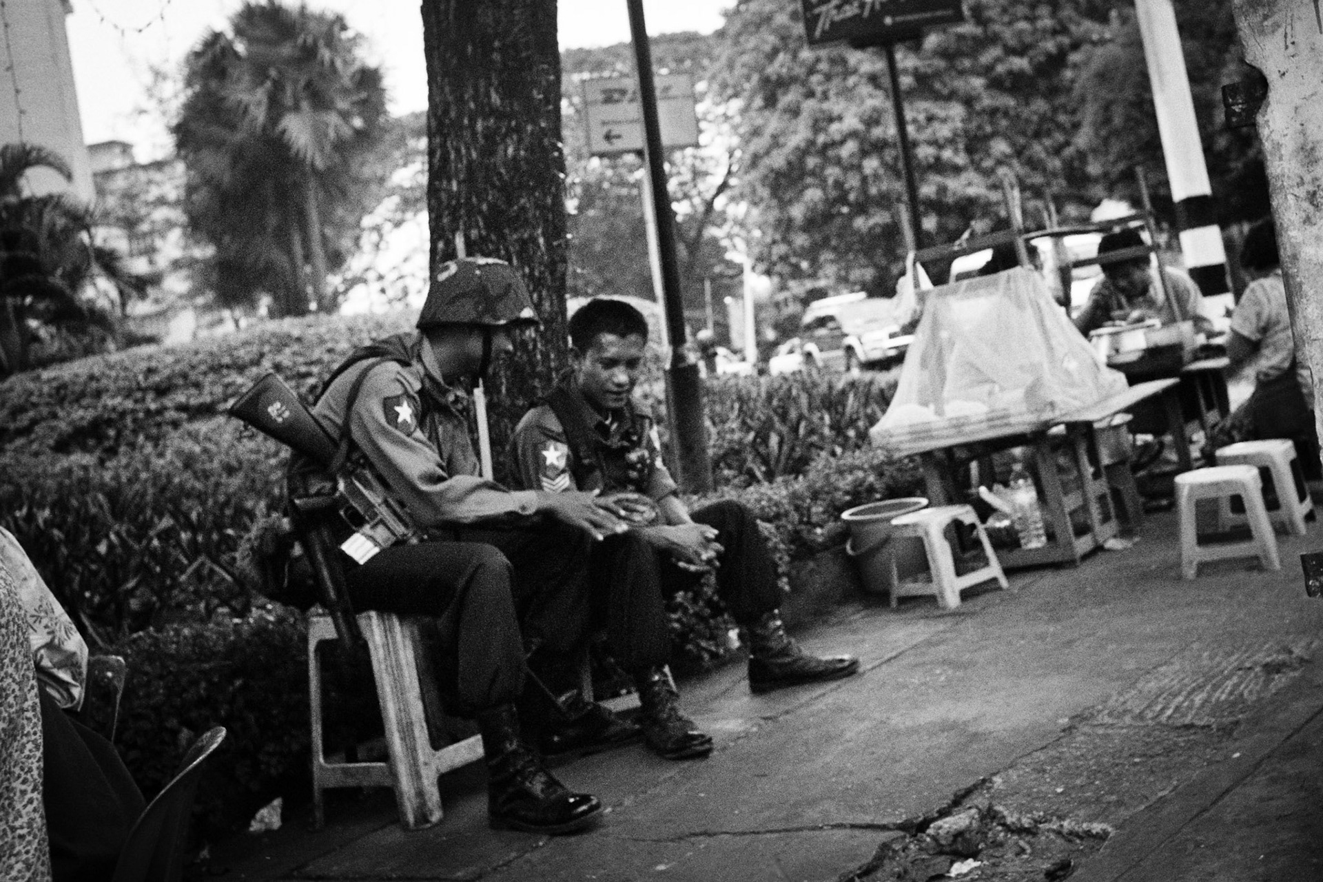 Young members of Burma's riot police sit in a tea shop in downtown Rangoon. The Burmese authorities keep a strict control on the public, allowing no form of dissent to their authoritarian rule.
