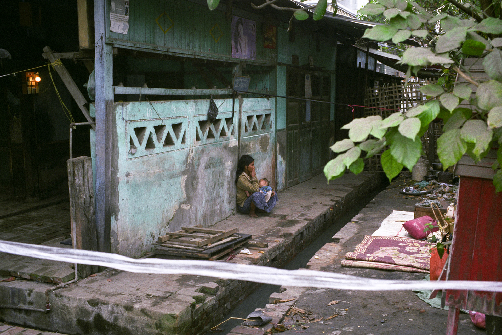A young women and her child forced to live on the streets through poverty. Burma, a resource rich nation, has become one of the poorest in the world with estimated more than 30% of the population living on or below the poverty line.