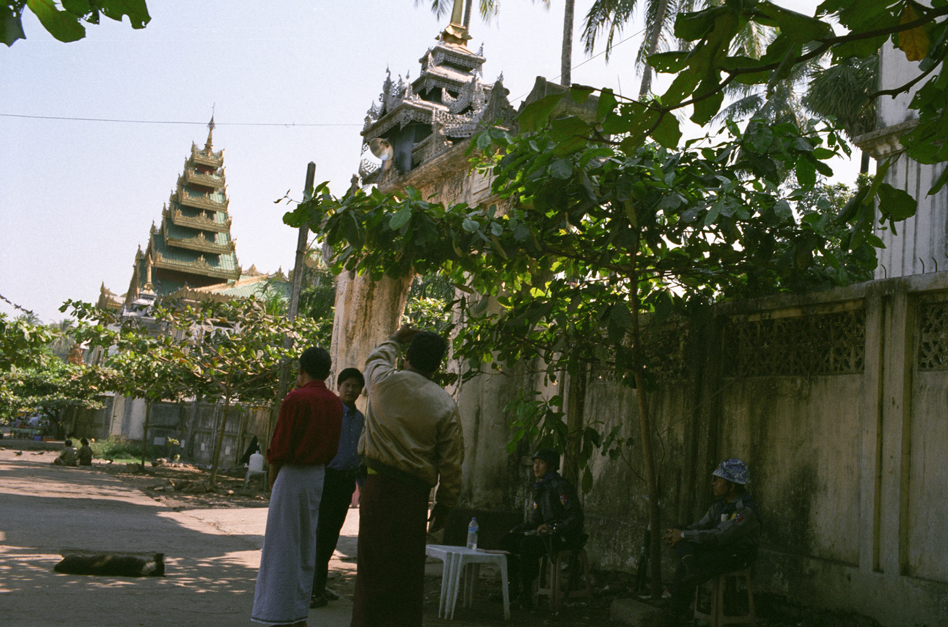 Military Intelligence officers and riot police outside a monastery that was raided during the monk led Saffron Revolution a month earlier and is now under the control of the authorities