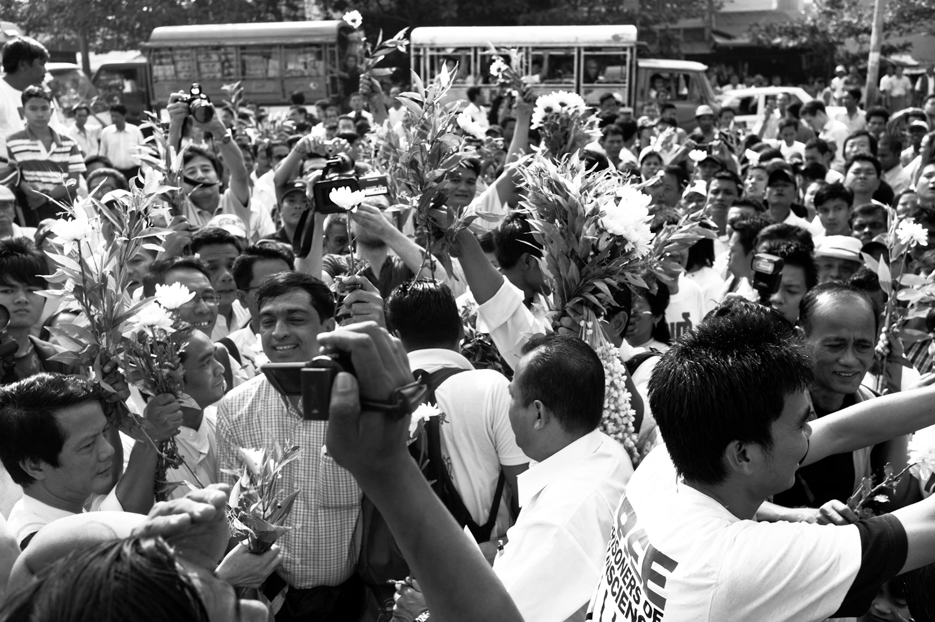 Crowds of hundreds including former political prisoners and democracy activists celebrate outside Insein prison in Rangoon, Burma, as hundreds of political prisoners including leading dissidents from the 88 Generation Students are released from prison under a presidential amnesty.