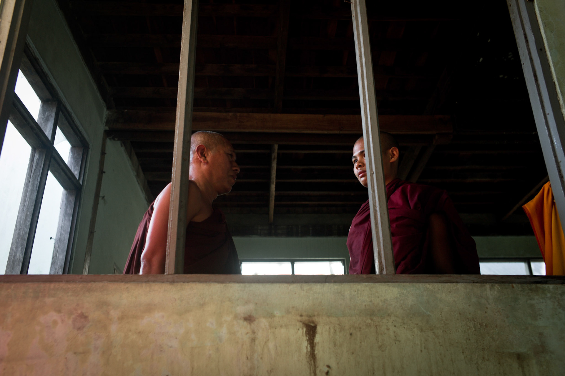 U Eindaka, the abbot of Maggin talks to his nephew, a young novice who has just joined the monastery. On September 26th 2007, at the height of Burma's monk led Saffron Revolution, Maggin Monastery in Rangoon, was raided as the regime commenced its brutal crackdown on the protests. On 13th January 2012 the monks were released from prison and more than four years since the monastery was raided and locked, they returned and opened the doors once more. Everything they found was exactly as it was left the night the military regime arrested them and ransacked the buildings.
