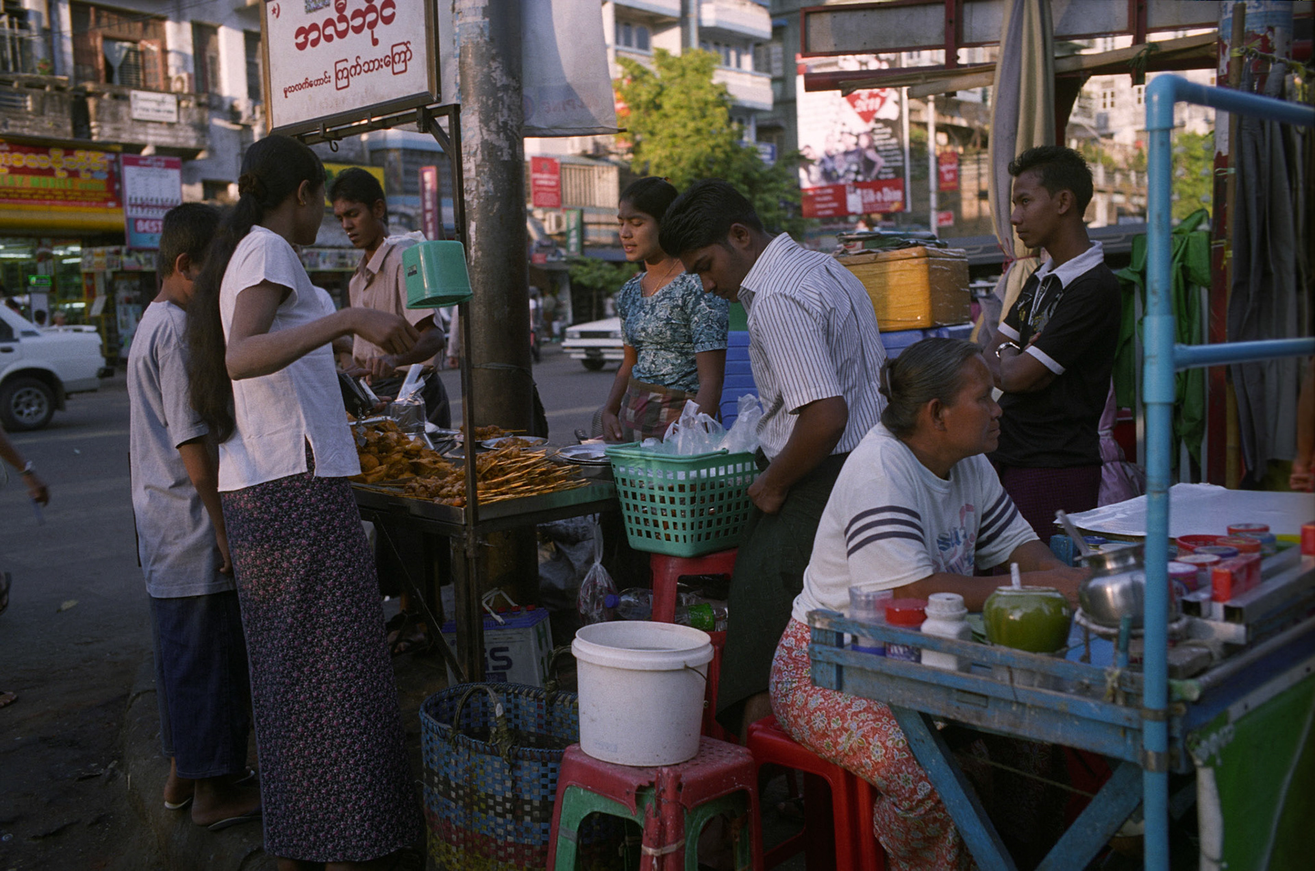 Daily life on the streets of Rangoon where vendors offer everything for sale from fresh food to bric-brac and discarded items. Burma, a resource rich nation, has become one of the poorest in the world with estimated more than 30% of the population living on or below the poverty line and where the ruling military regime spend less than 2% of GDP on education and healthcare combined.