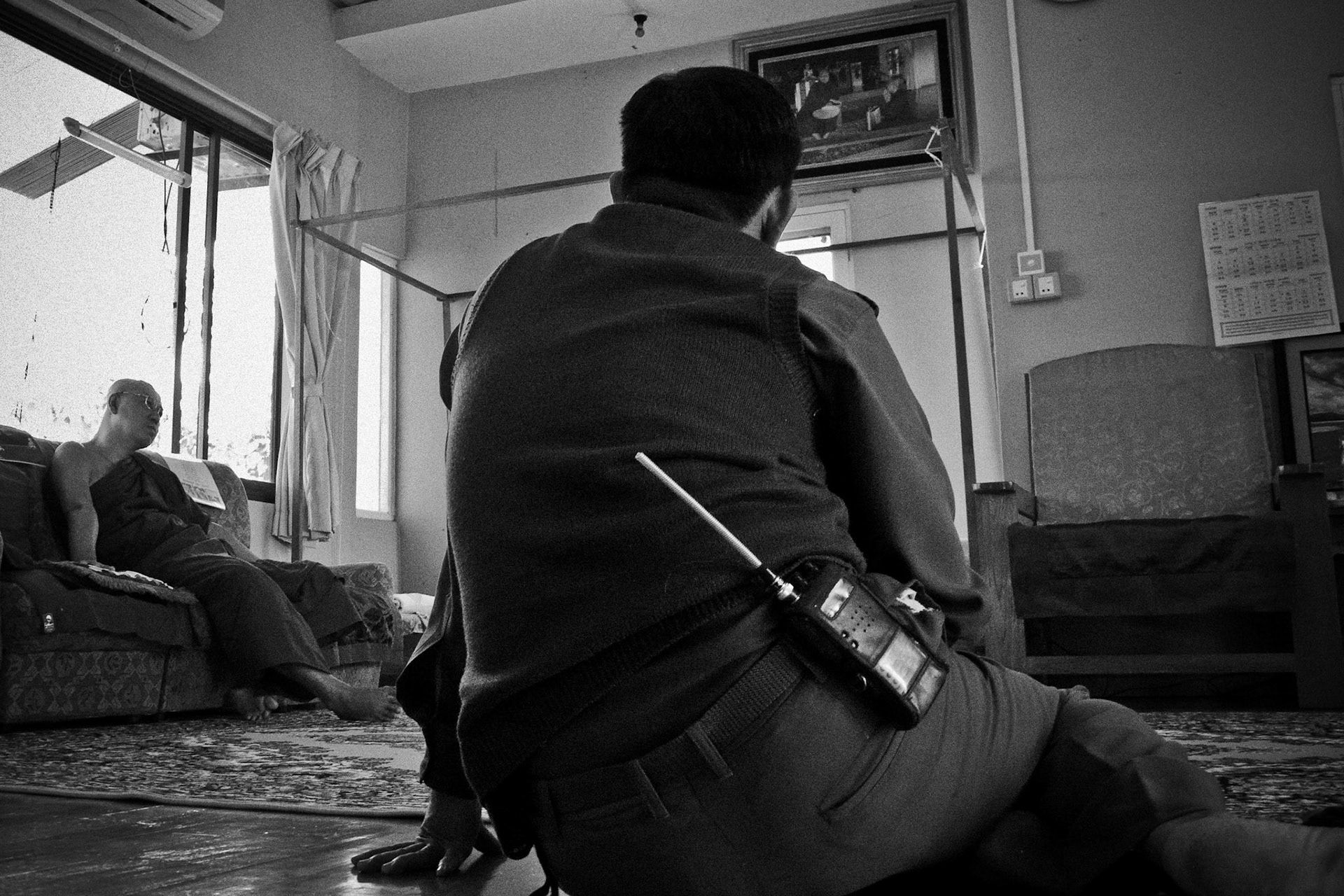 A Burmese army officer talks to monks. In September 2007, thousands of protesters took to the streets of Rangoon to demonstrate against Burma's military regime. Three months later and the streets are quiet in a climate of fear.