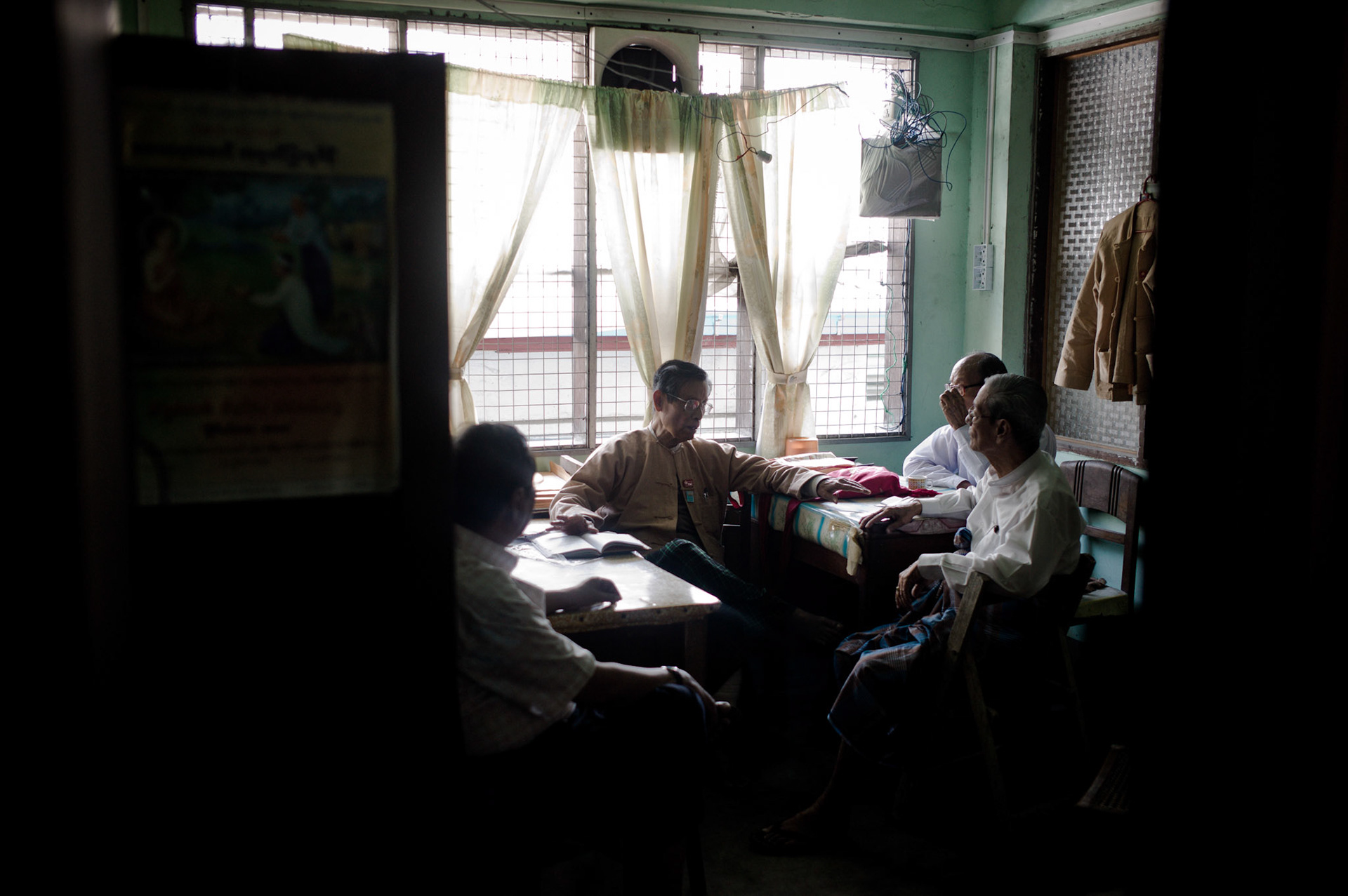 Former Vice Chairman of the party, U Tin Oo meets with other senior Executive Committee members of the NLD in the office upstairs. The run down office that is the headquarters of Burma's opposition party, the National League for Democracy, has once again become a hive of activity as the party reforms and with democracy icon Aung San Suu Kyi at the helm, leads the way to bring democratic change to the country