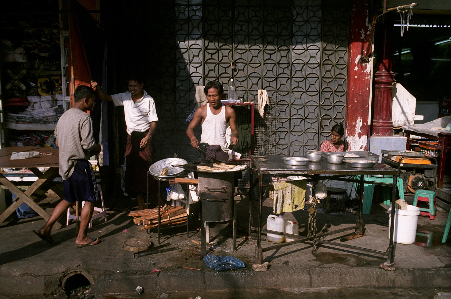 Daily life on the streets of Rangoon where vendors offer everything for sale from fresh food to bric-brac and discarded items. Burma, a resource rich nation, has become one of the poorest in the world with estimated more than 30% of the population living on or below the poverty line and where the ruling military regime spend less than 2% of GDP on education and healthcare combined.