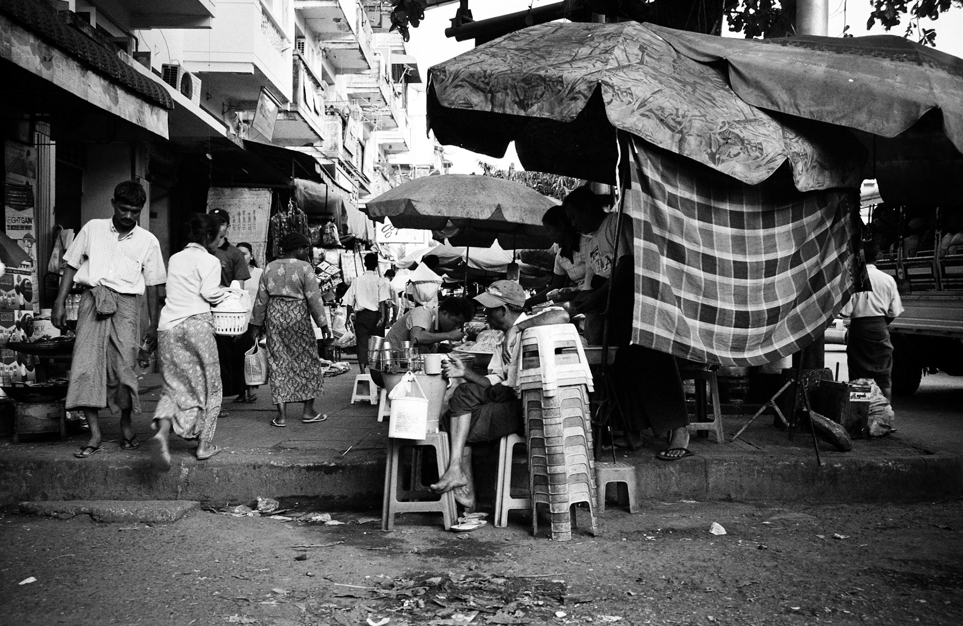 Daily life on the streets of Rangoon where vendors offer everything for sale from fresh food to bric-brac and discarded items. Burma, a resource rich nation, has become one of the poorest in the world with estimated more than 30% of the population living on or below the poverty line and where the ruling military regime spend less than 2% of GDP on education and healthcare combined.
