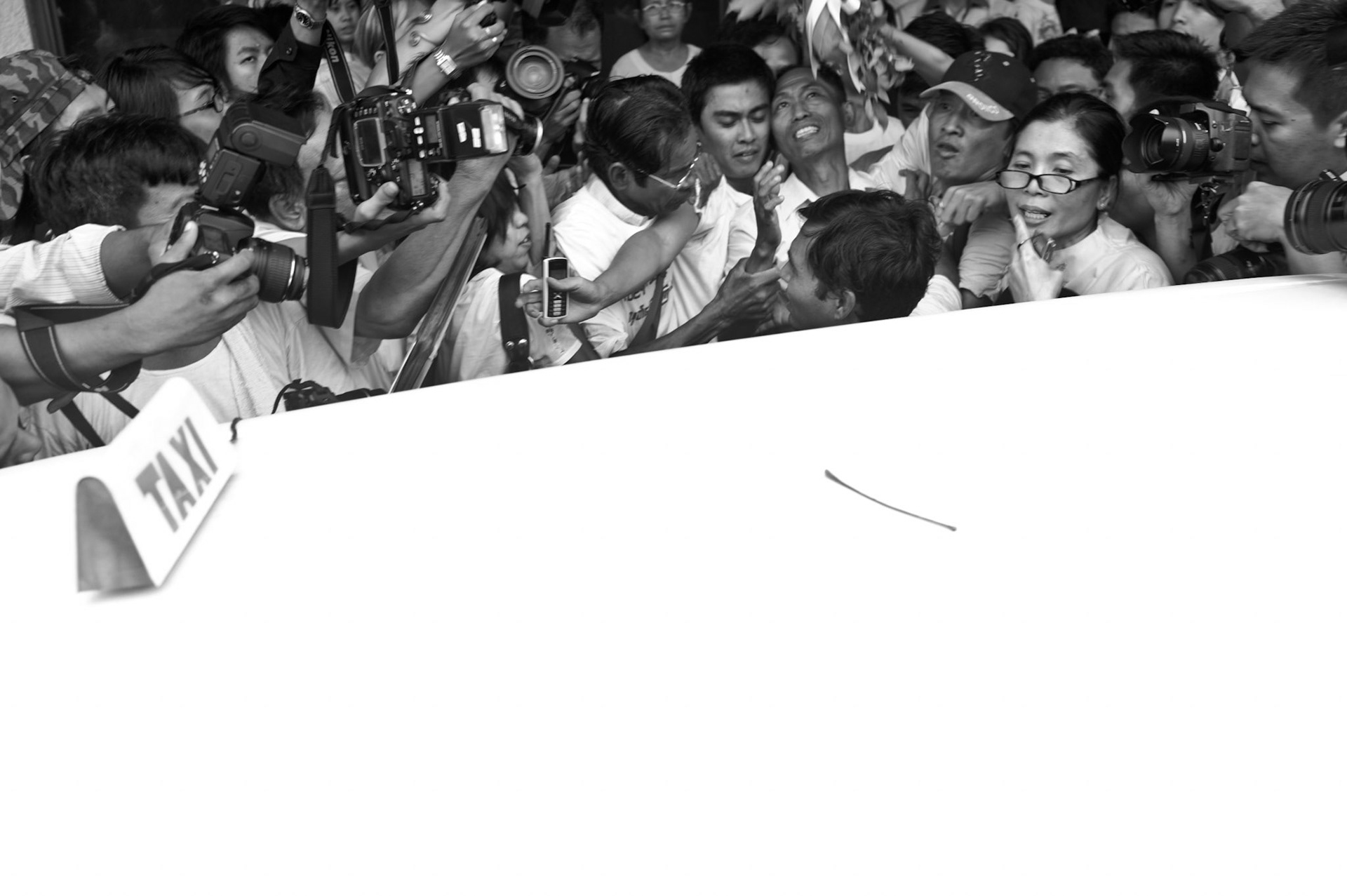 88 Generation Student leader Ko Ko Gyi is mobbed by hundreds of well wishers and dissidents as he arrives in Rangoon airport. The Presidential amnesty saw more than 600 political prisoners released from prison, many of who were former leaders of the mass democracy uprising in 1988 and were serving long sentences of 65 years or more.